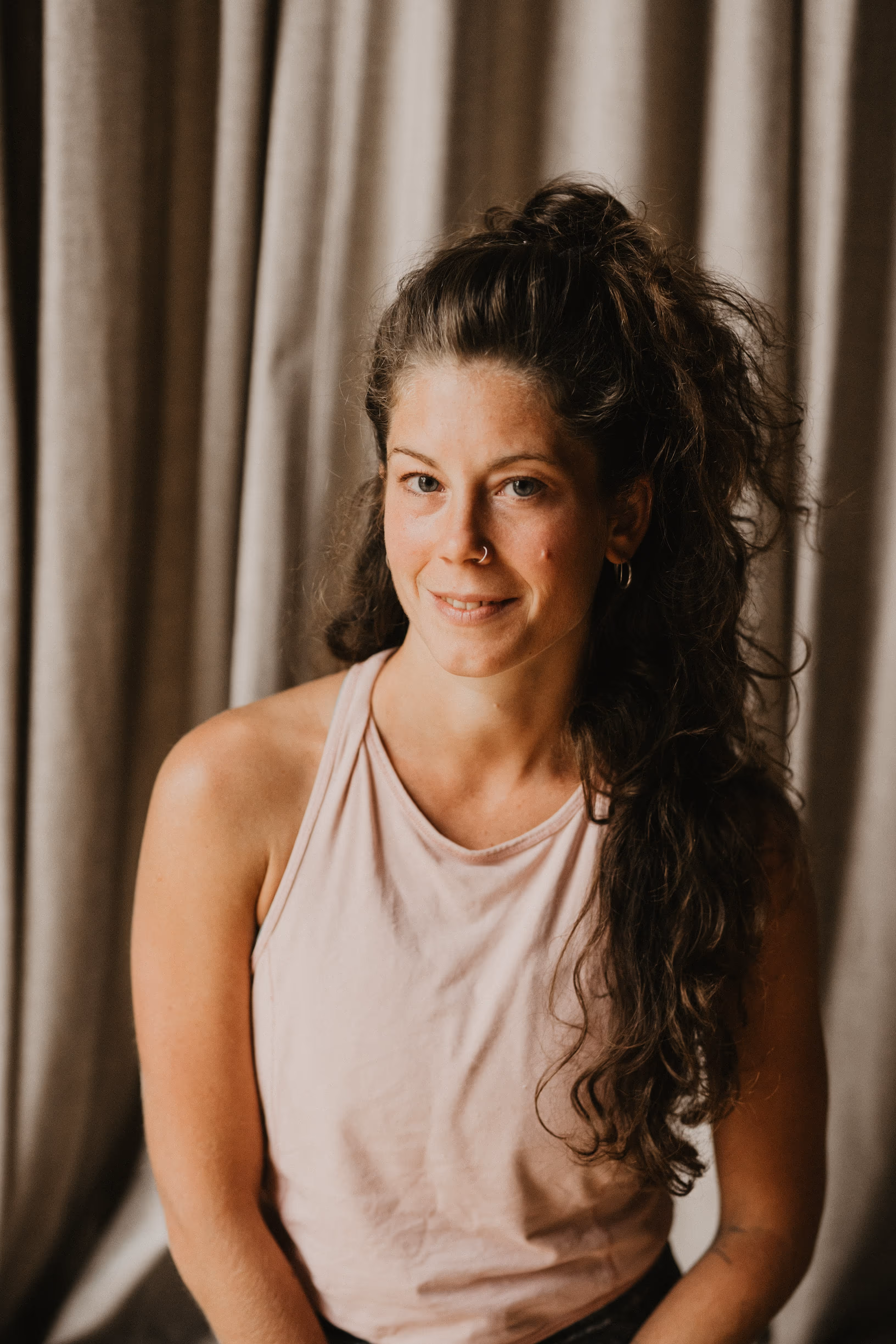 An image of smiling woman, she's a yoga teacher