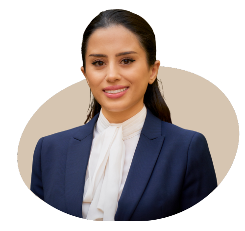 A professional portrait of the director of a private medical insurance brokerage, dressed in a business suit, standing in a modern office setting with a confident and approachable expression.