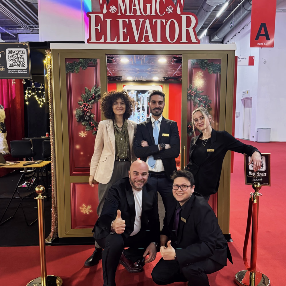 Team Menart presents Magic Elevator for Christmas during a trade fair, showing an interactive scenographic installation with gold decorations and professional finishes.