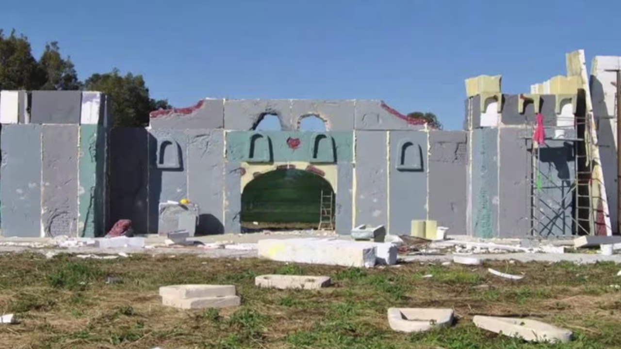 Scenography construction in polystyrene with painted architectural structures, showing the Menart set-up process for large scale Christmas installations.