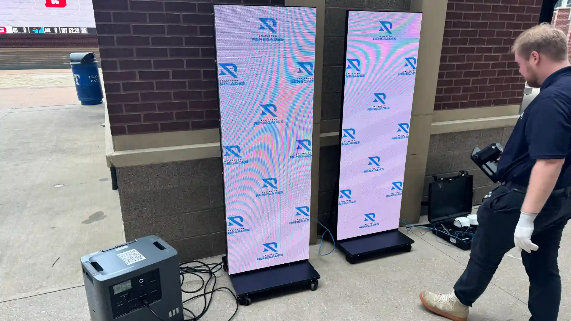 Conner setting up LED posters for Renegades activation.