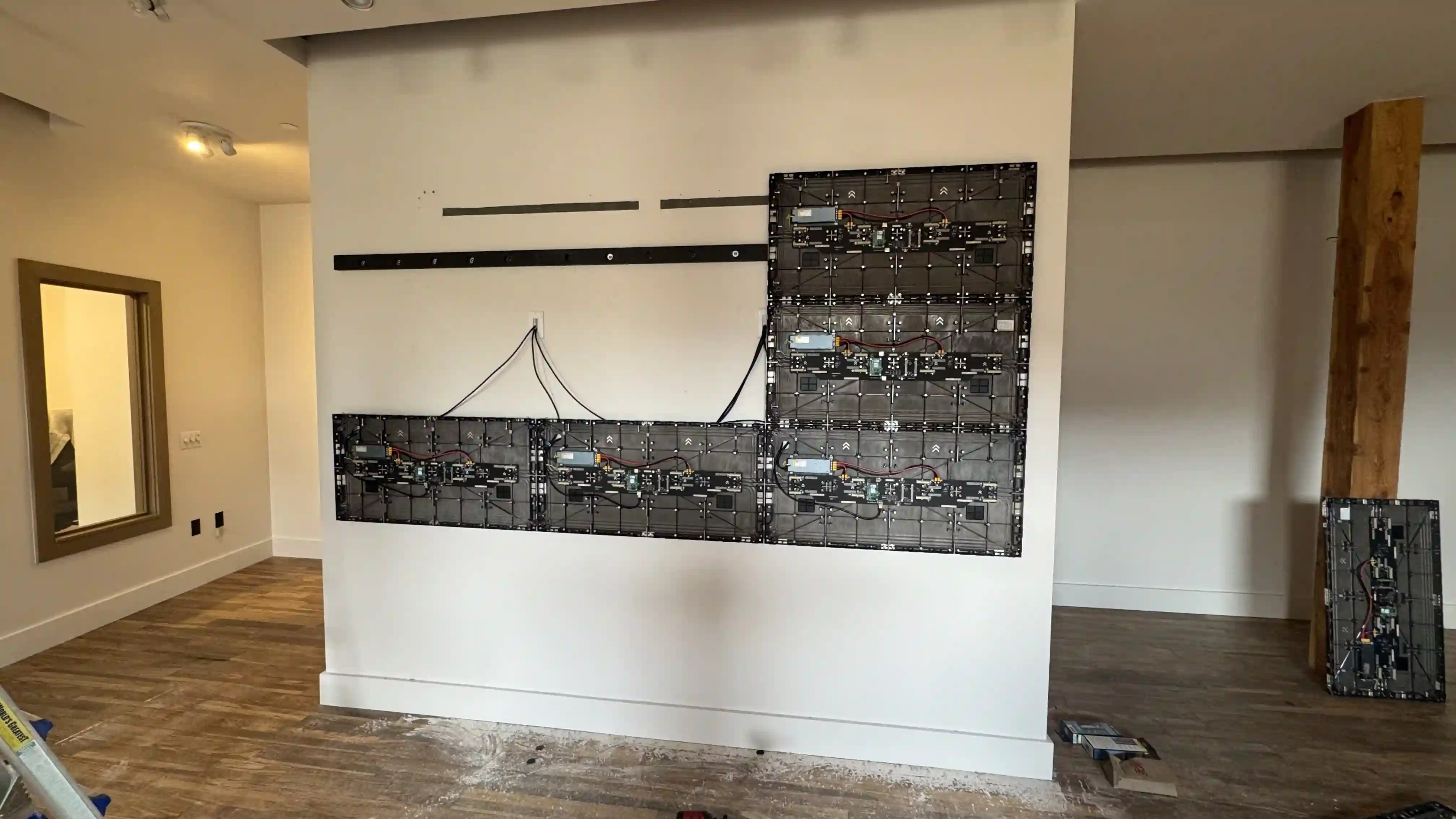 LED video wall cabinets being mounted inside Jackson Hole Jewelry Company retail space during installation process by CMG Visuals.