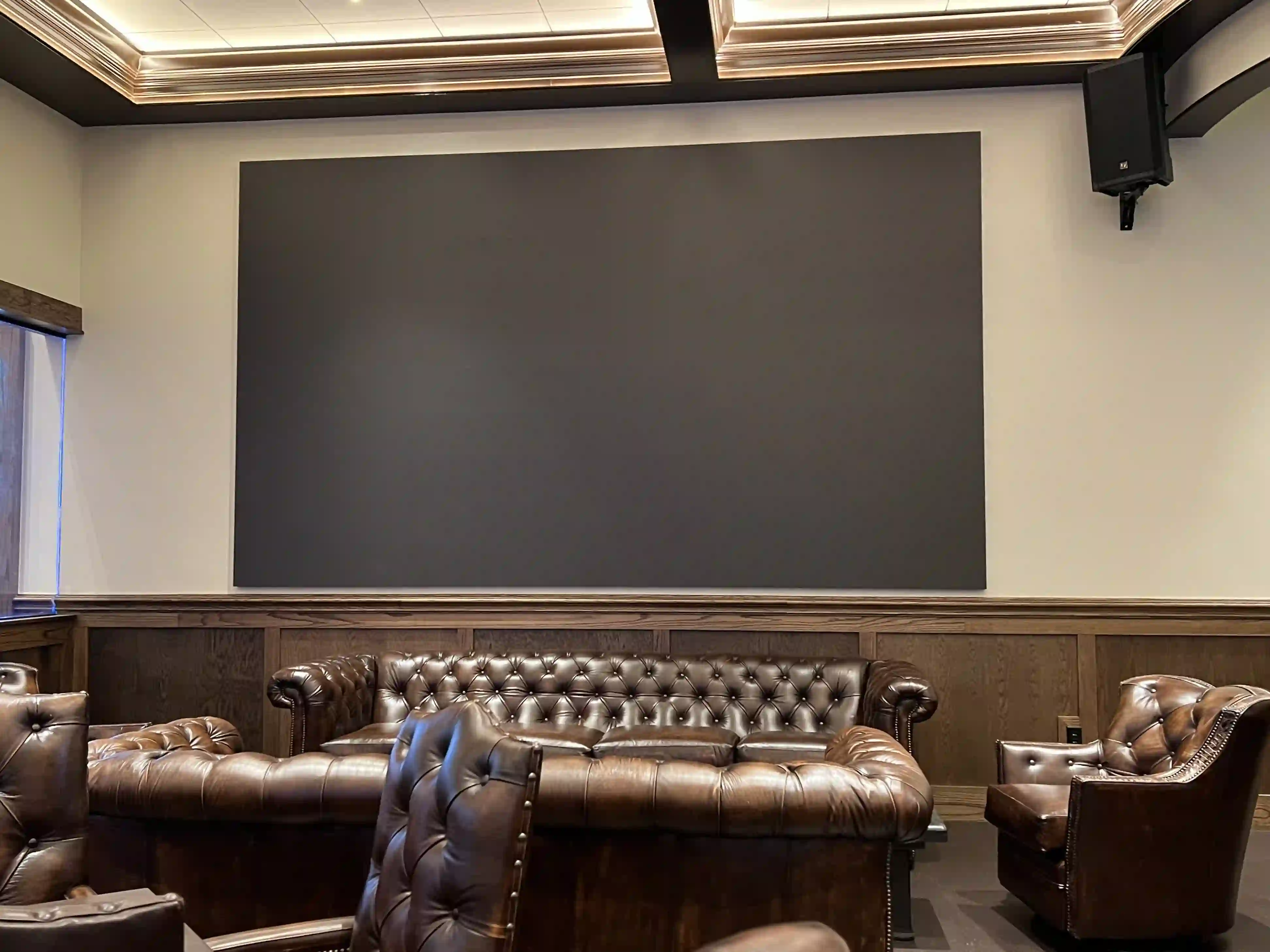 Completed LED video wall installation by CMG Visuals in a private lounge, blending seamlessly into the space with leather seating and wood accents.