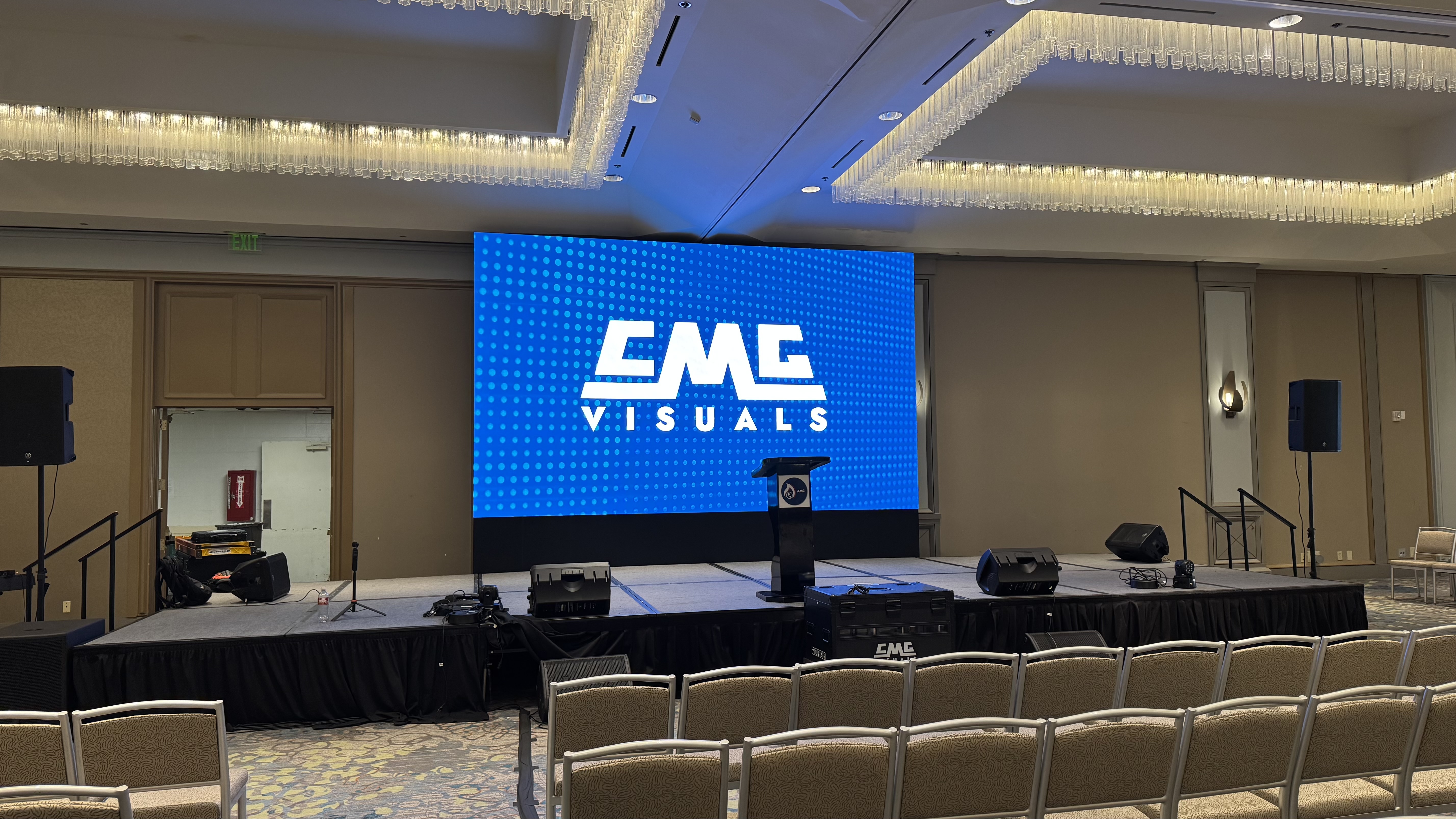 LED video wall stage backdrop in a hotel ballroom with CMG Visuals logo.