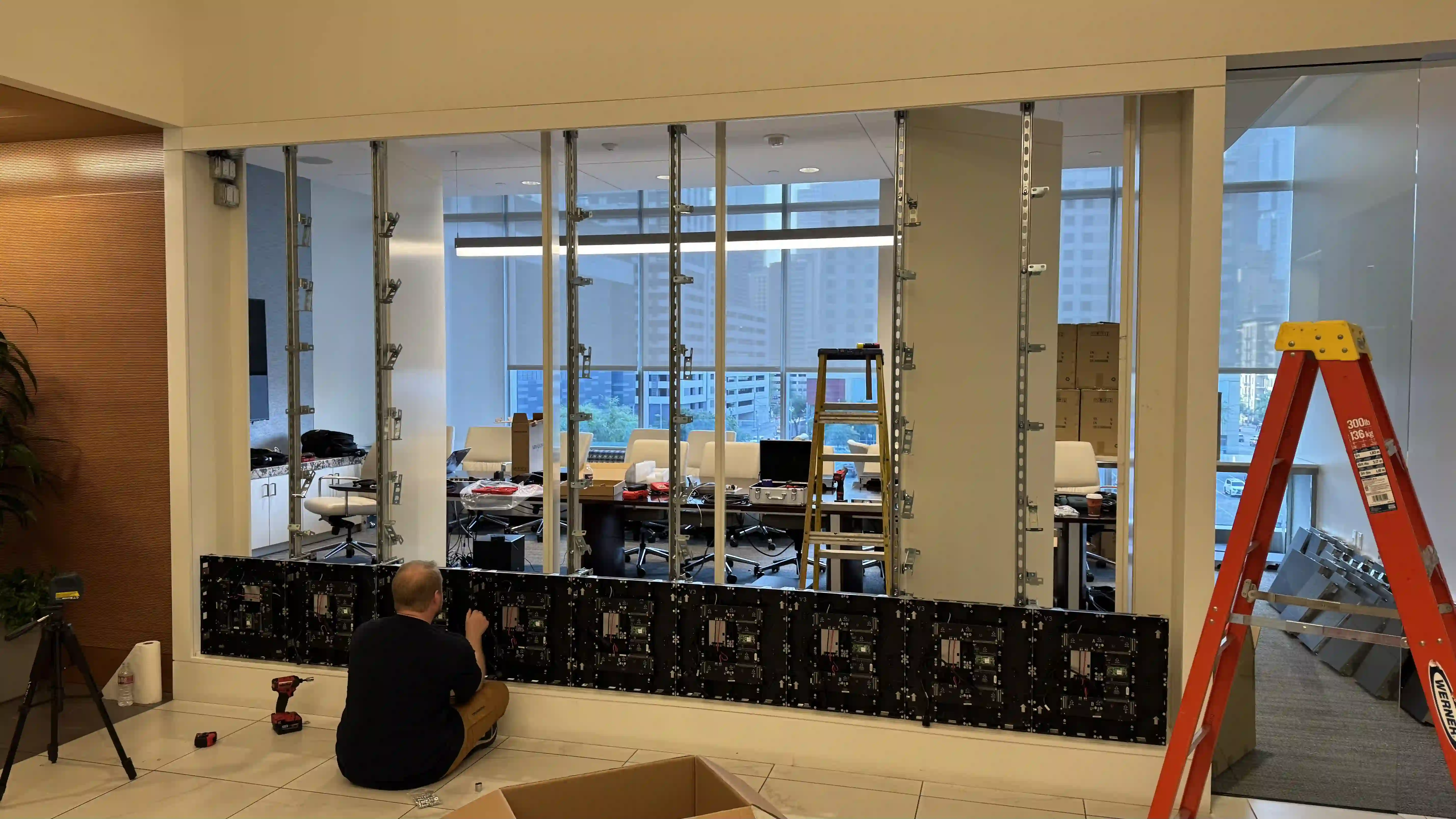 Technician installing a P1.9 LED video wall (14.17×7.87 ft) on the existing frame at Harris County Sports Authority, Houston.
