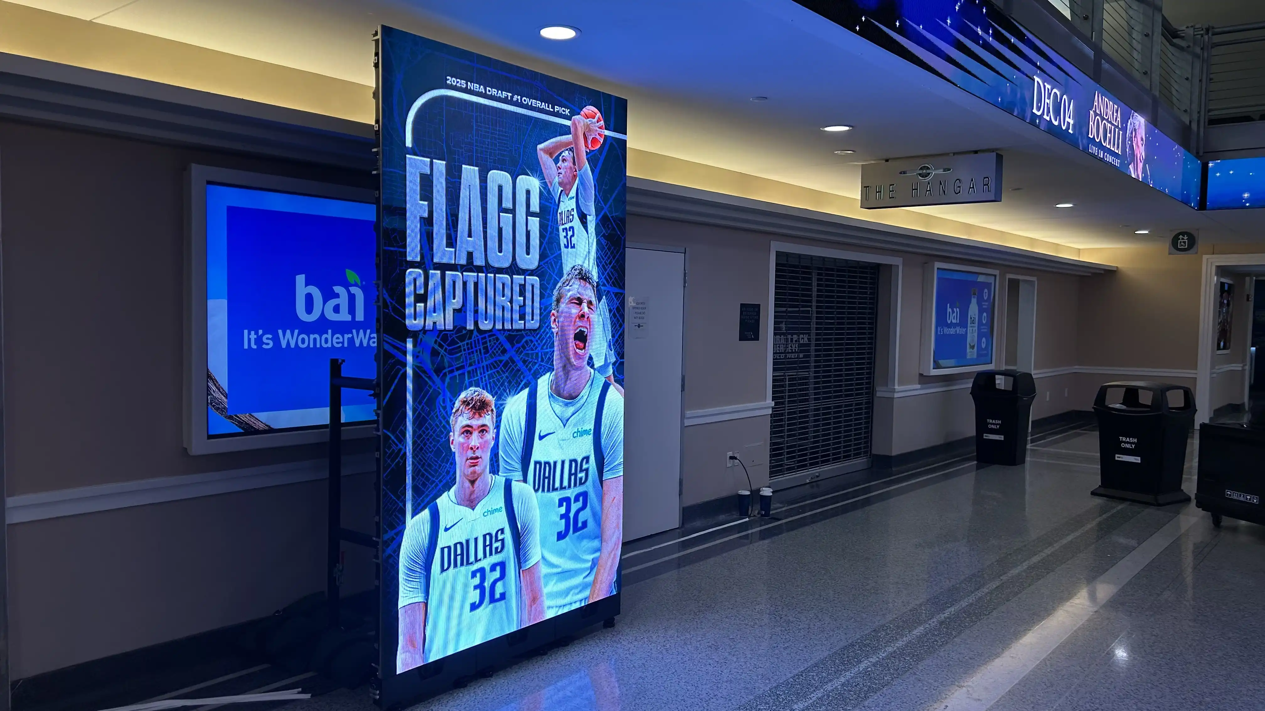Digital signage featuring the Mavericks’ No. 1 draft pick image with “Flagg Captured” headline, powered by Novastar Taurus and Peplink 5G setup.