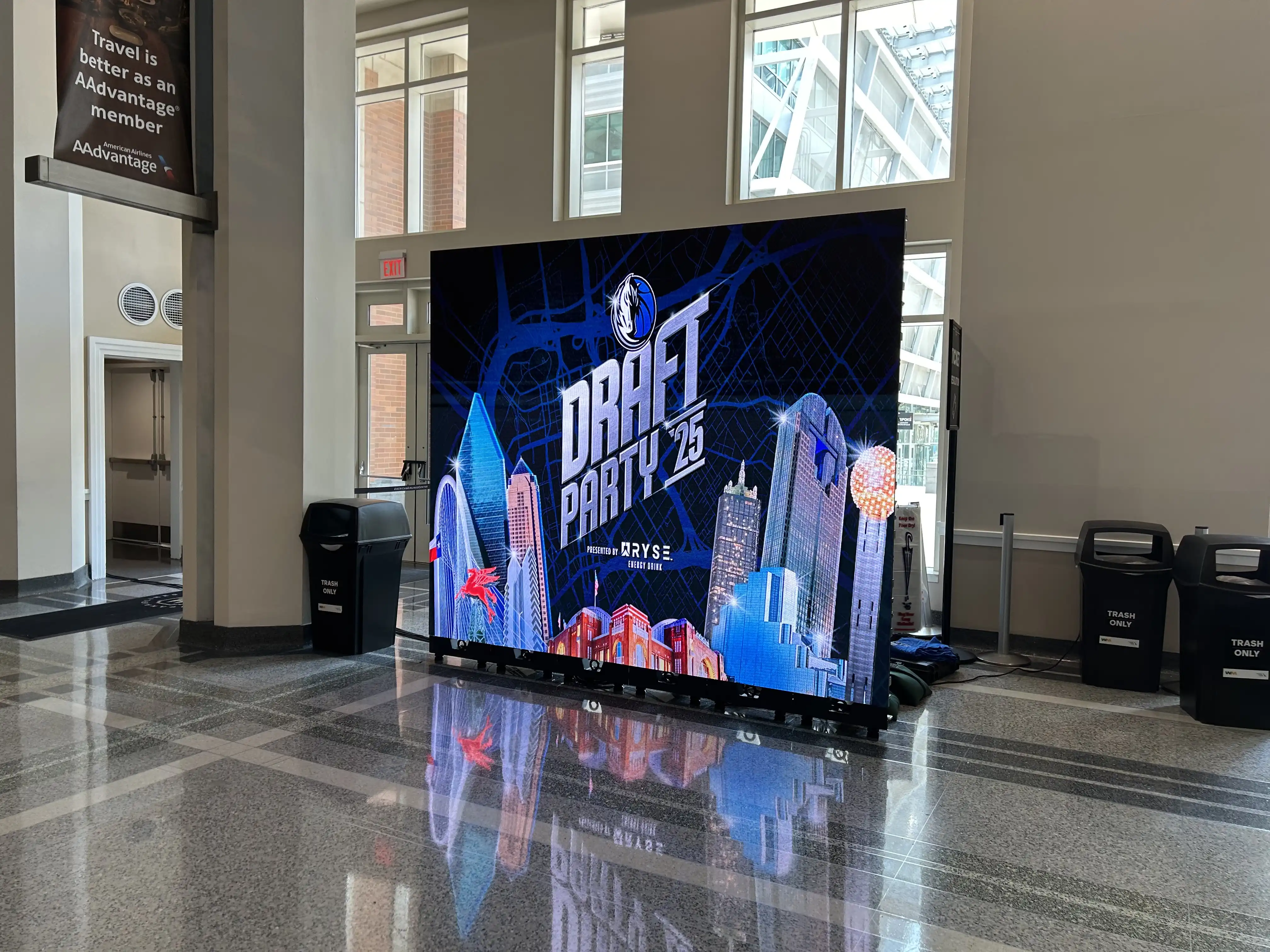High-resolution P2.6mm LED digital signage showcasing Draft Party visuals near the main entrance of American Airlines Center in downtown Dallas.