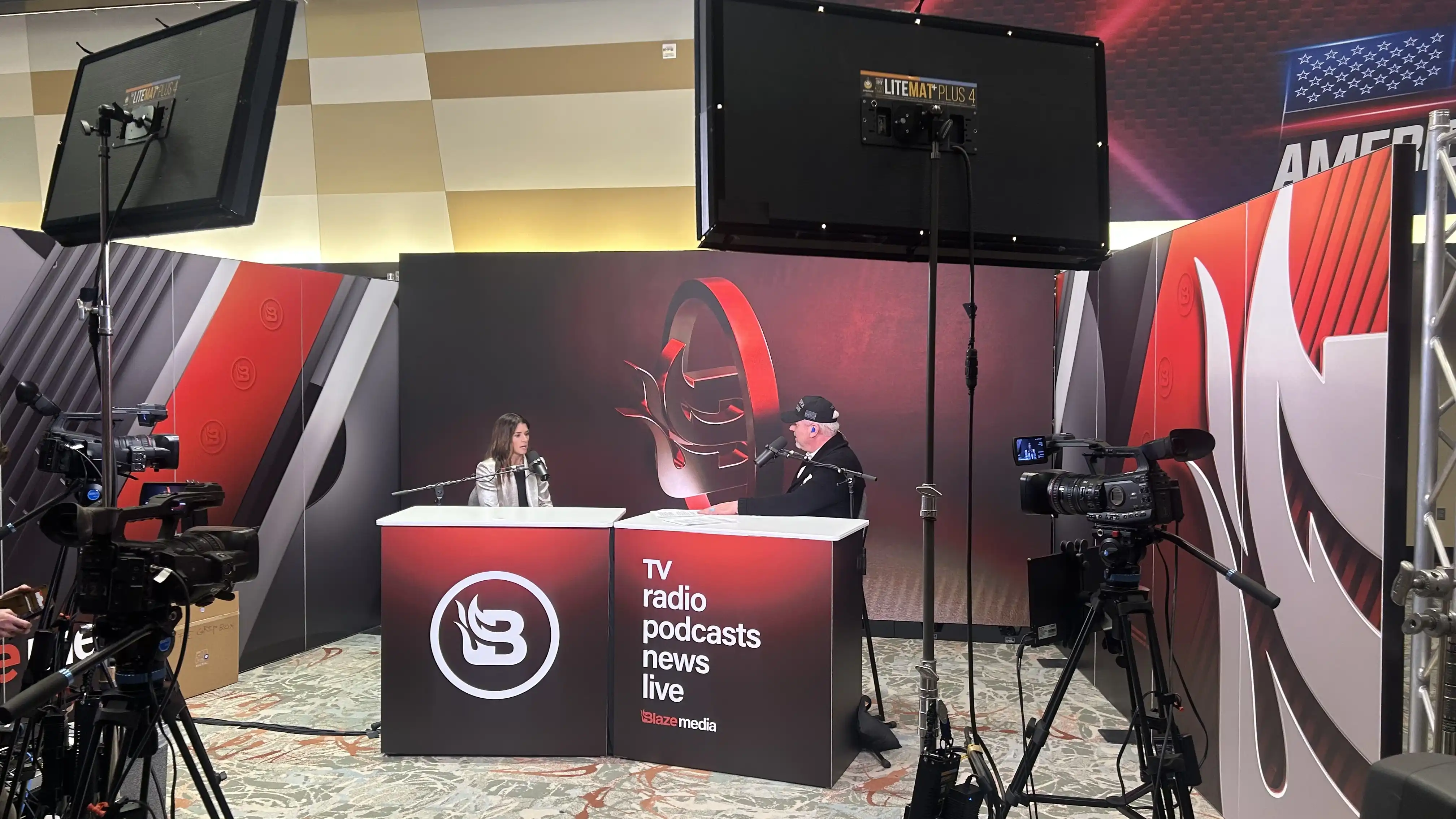 Danika Patrick talking on camera at the TPUSA conference.