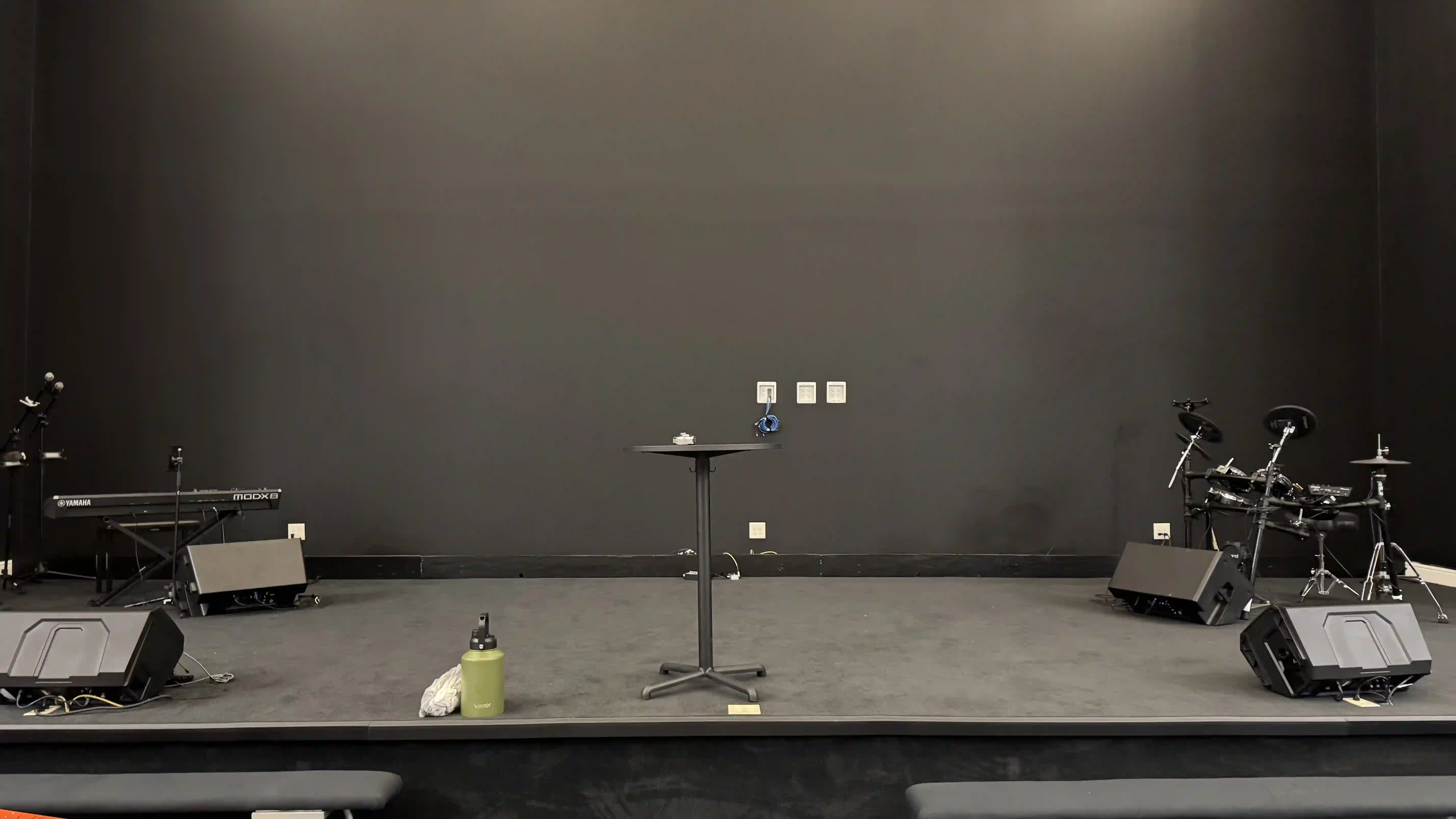 Before: blank stage wall at Keystone Church Mesquite, Texas, prior to LED screen installation, instruments set on stage.