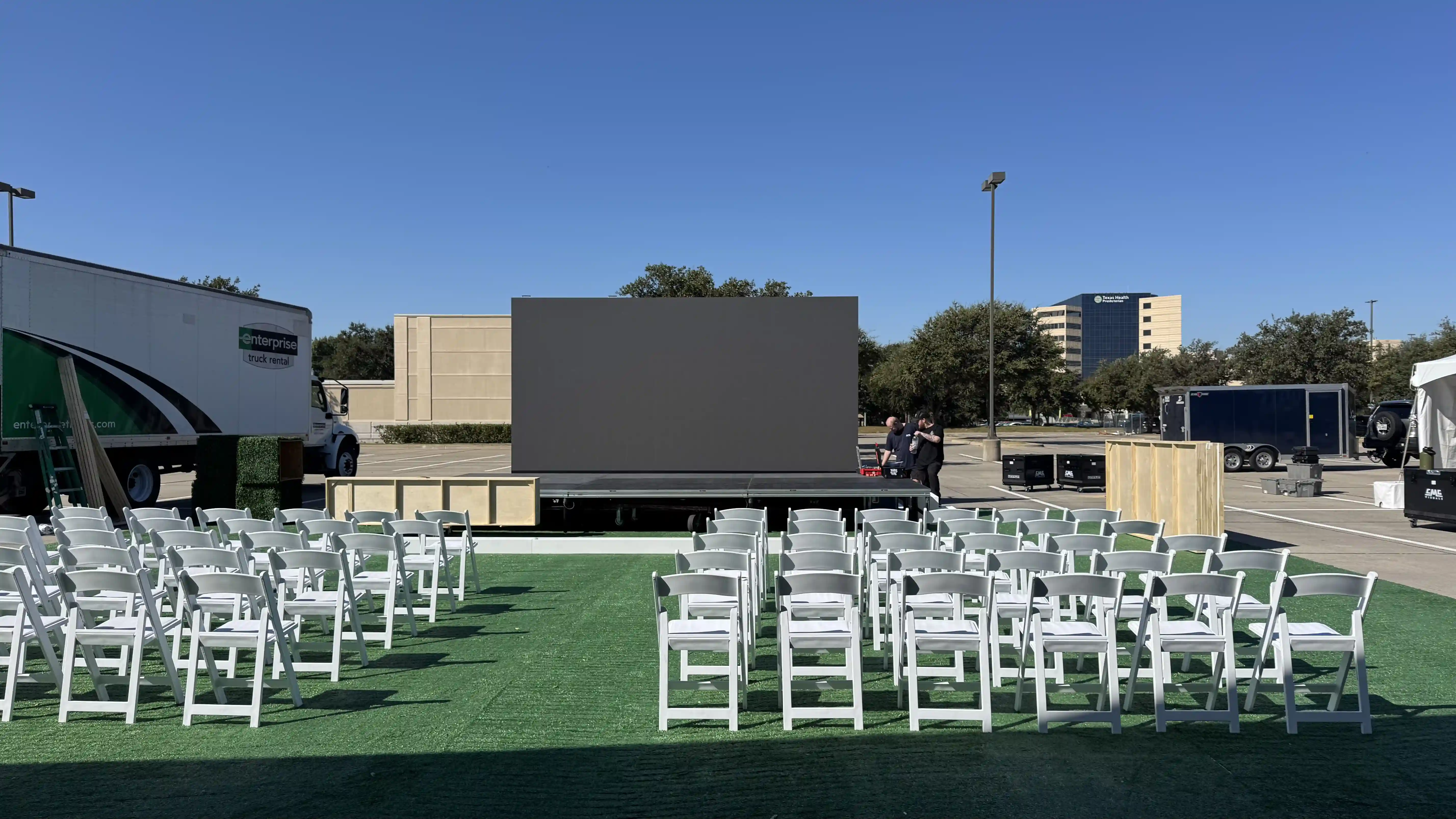 Outdoor LED video wall installed on a stage with seating for the Texas Health Plano Tower groundbreaking event.