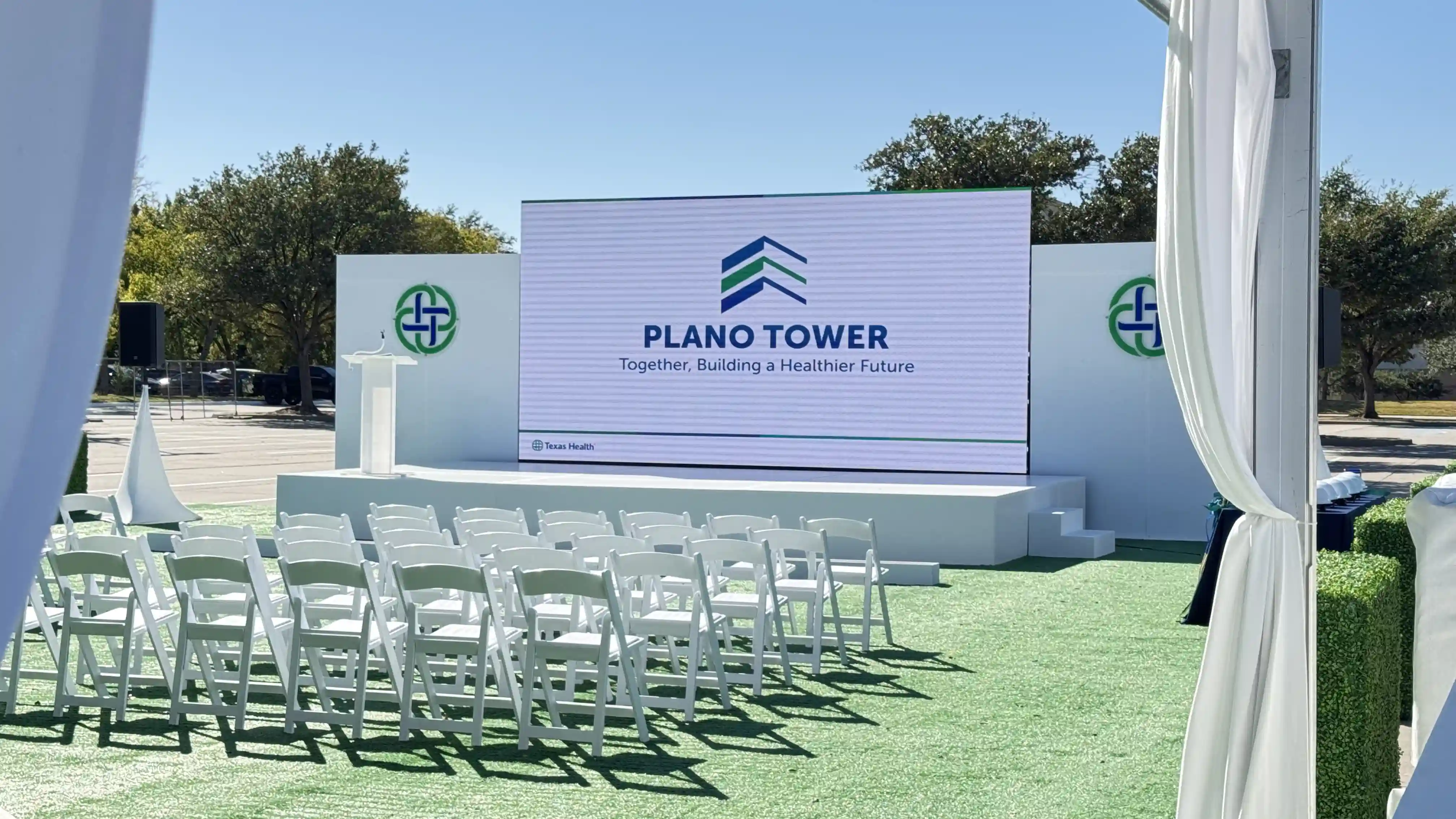 Outdoor LED screen displaying Plano Tower branding at the Texas Health groundbreaking ceremony.