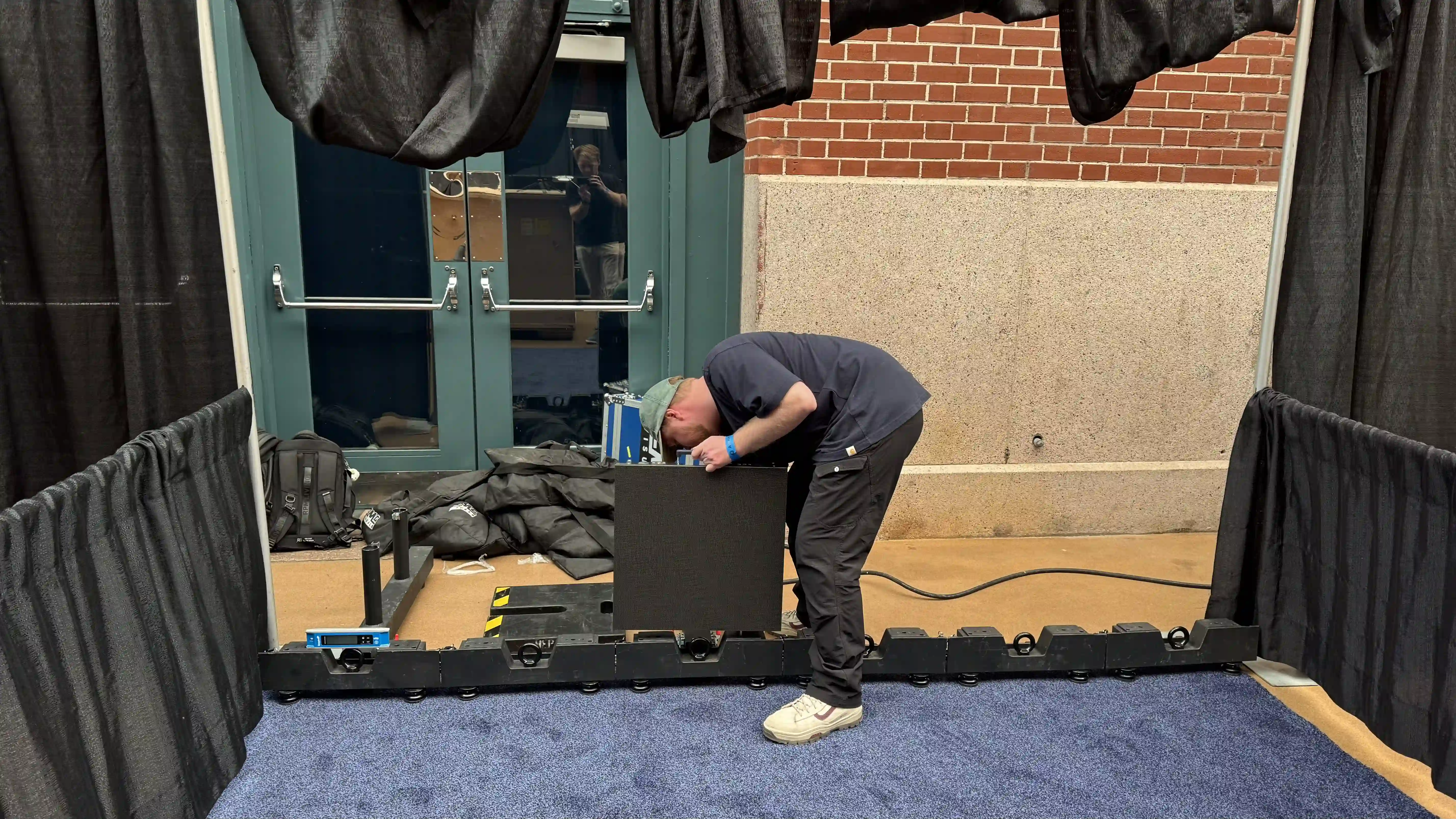 Technician assembling 10x10 trade show LED screen rental for Enerbine at Thrive 2026 energy conference in Houston