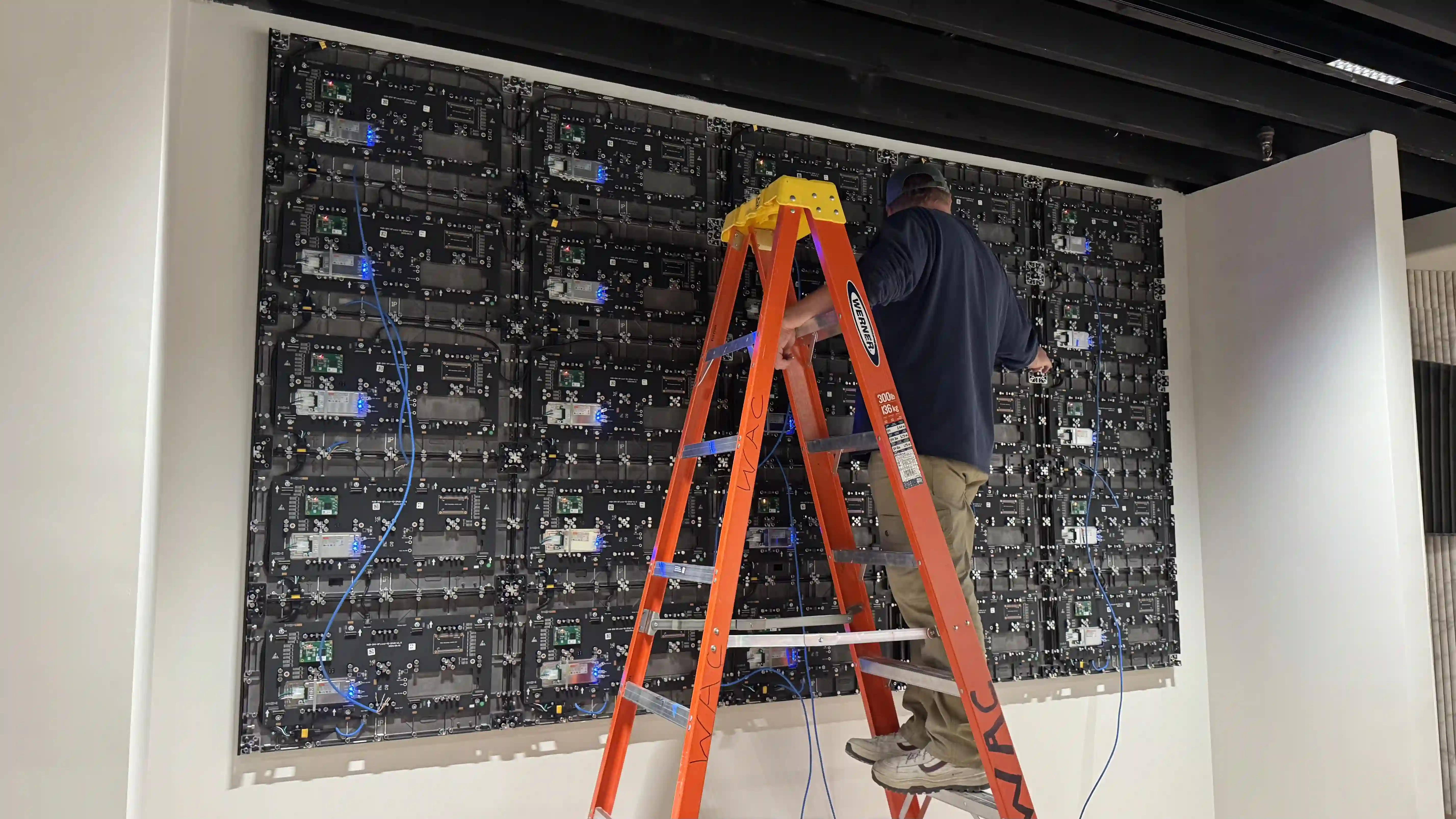 LED video wall installation process showing 0.9mm panels and wiring in Long Island NY corporate space