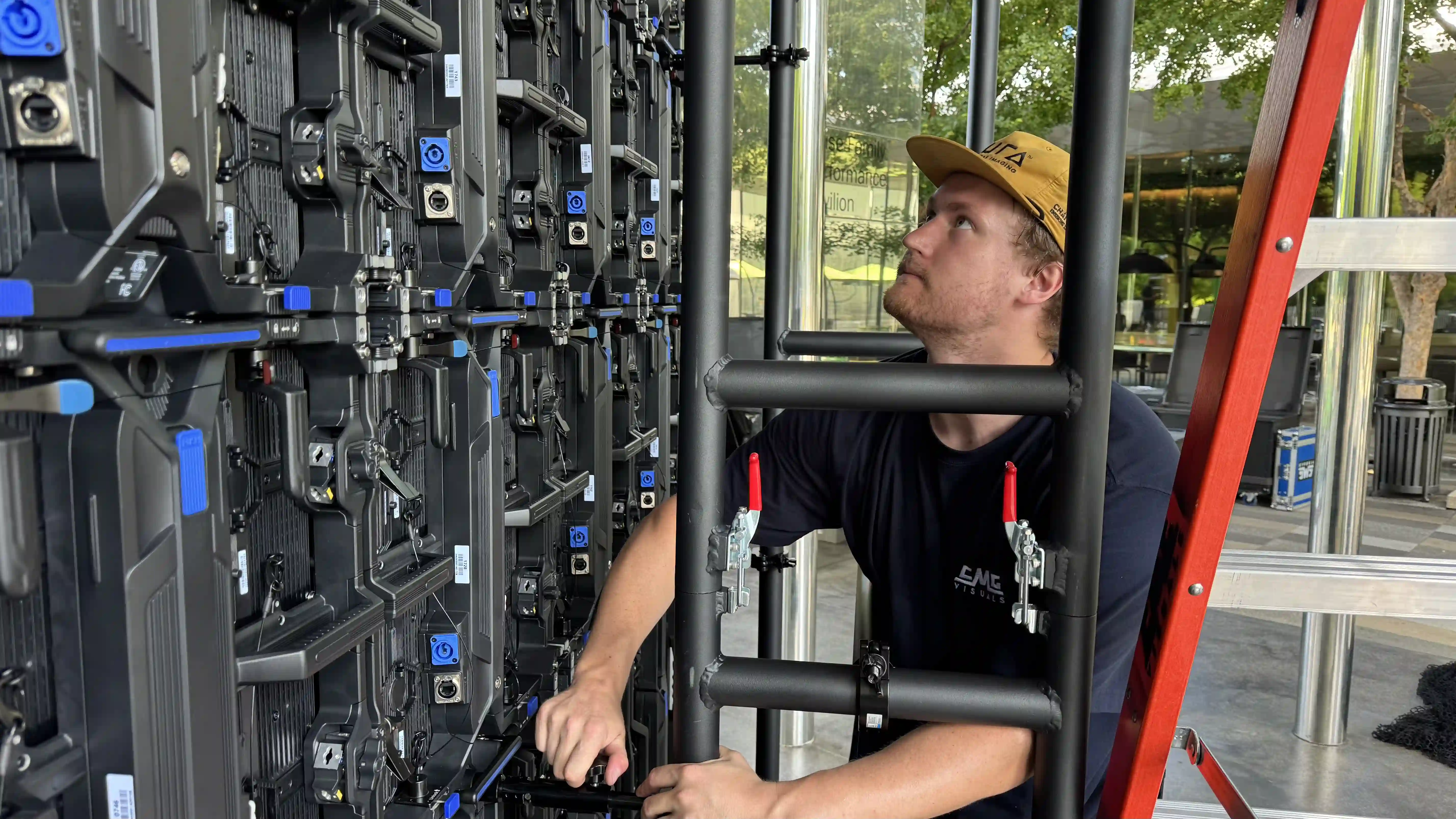 LED video wall installation technician working on panel system and wiring
