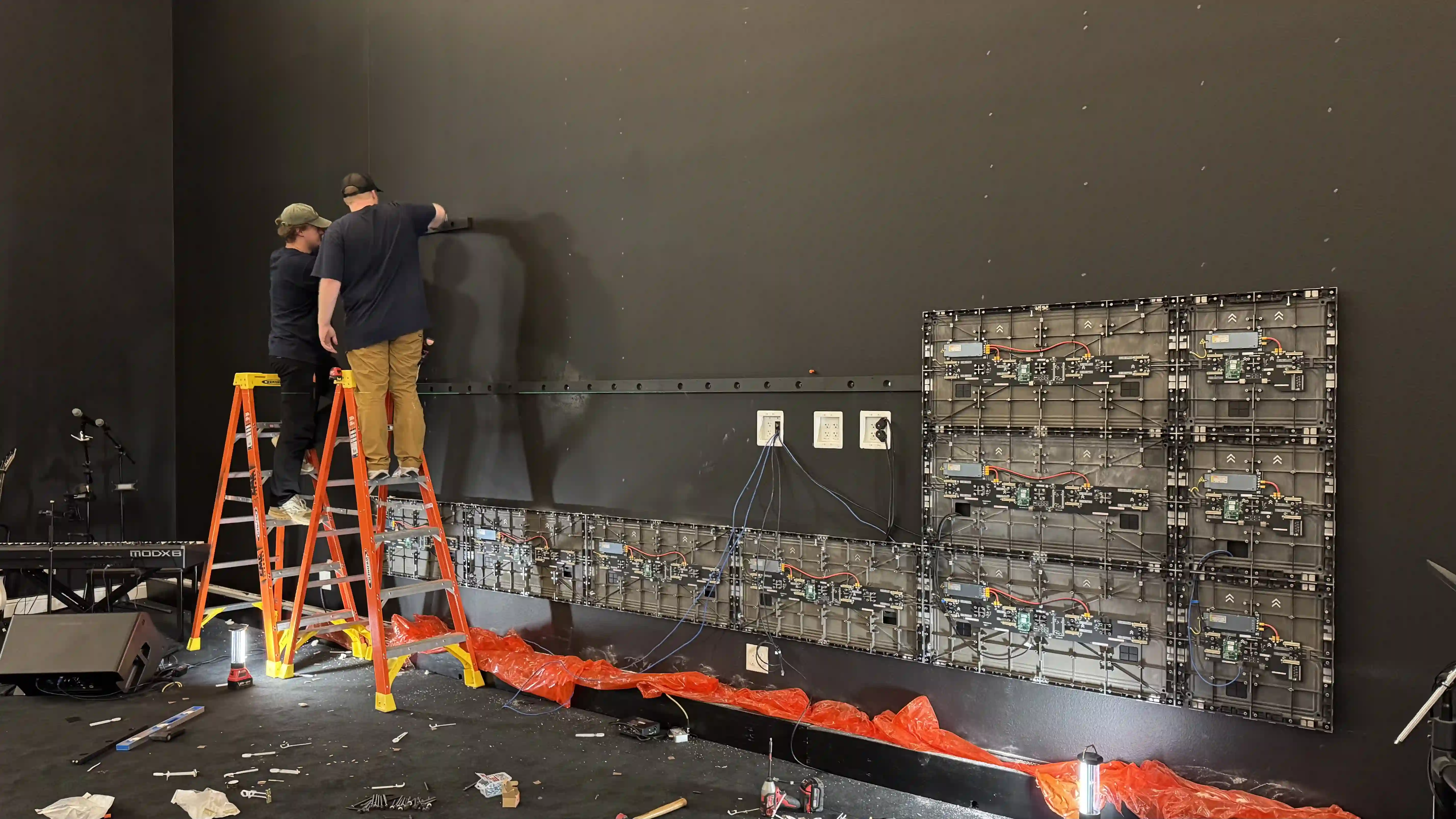 LED video wall installation in progress with technicians mounting panels