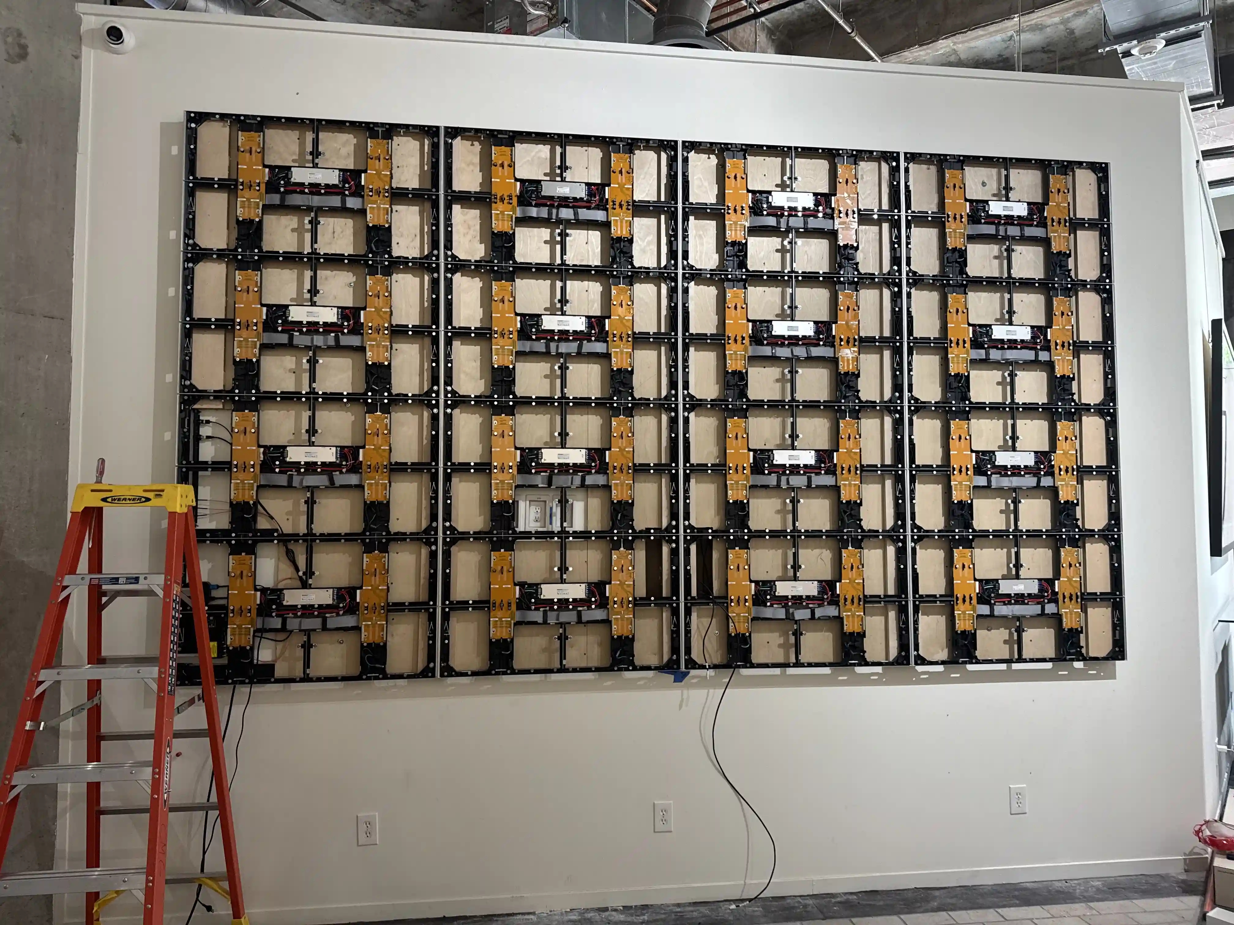 LED video wall installation showing backend structure, mounting, and wiring during setup