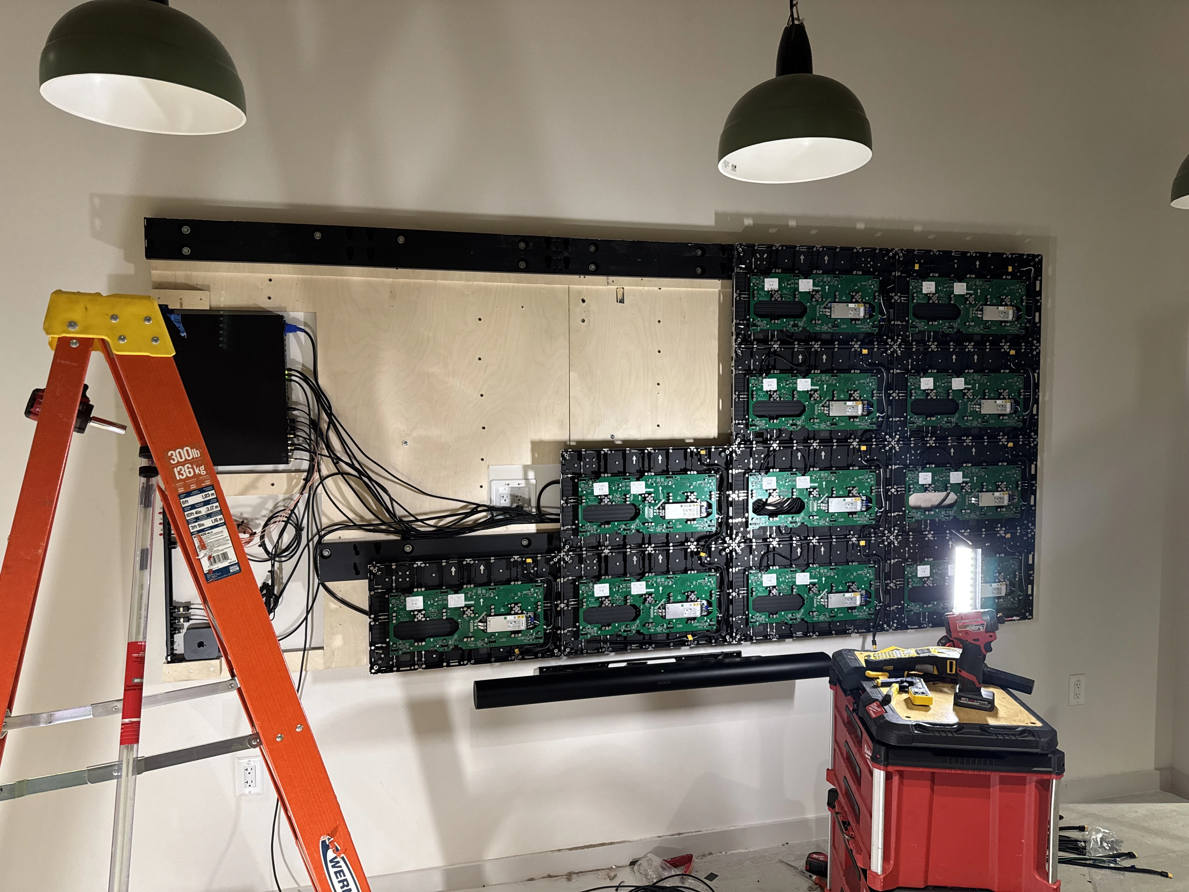 CMG Visuals installing LED display panels on a mounting frame at Compass Datacenters