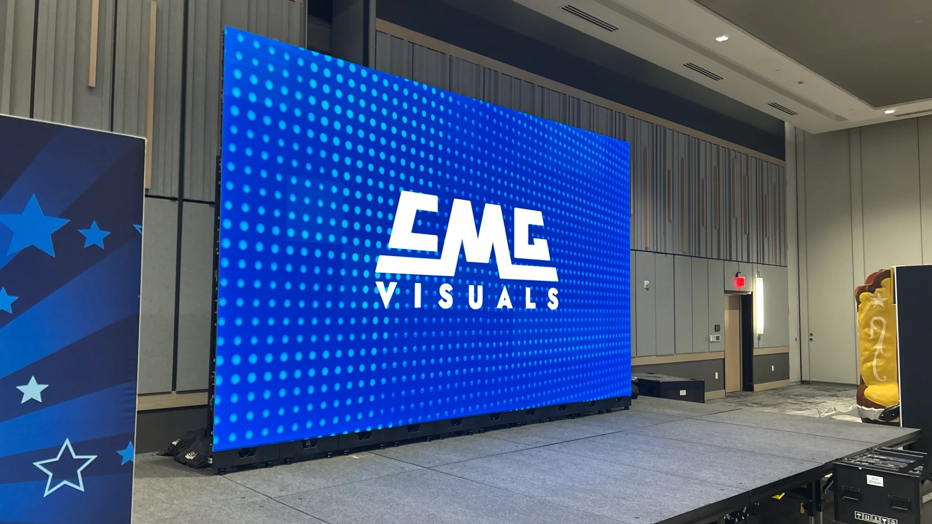 Stage LED video wall displaying CMG Visuals branding at event