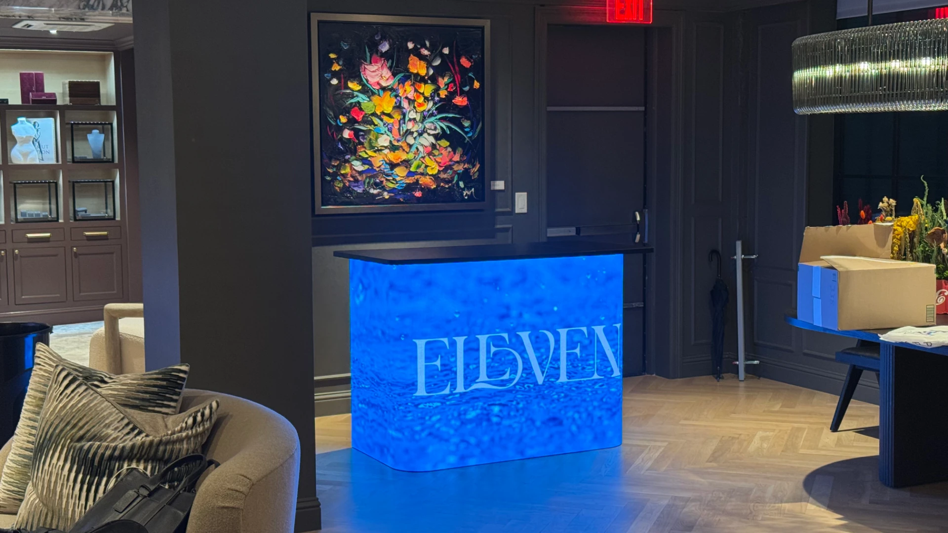 LED DJ booth glowing blue with ELEVEN logo at event