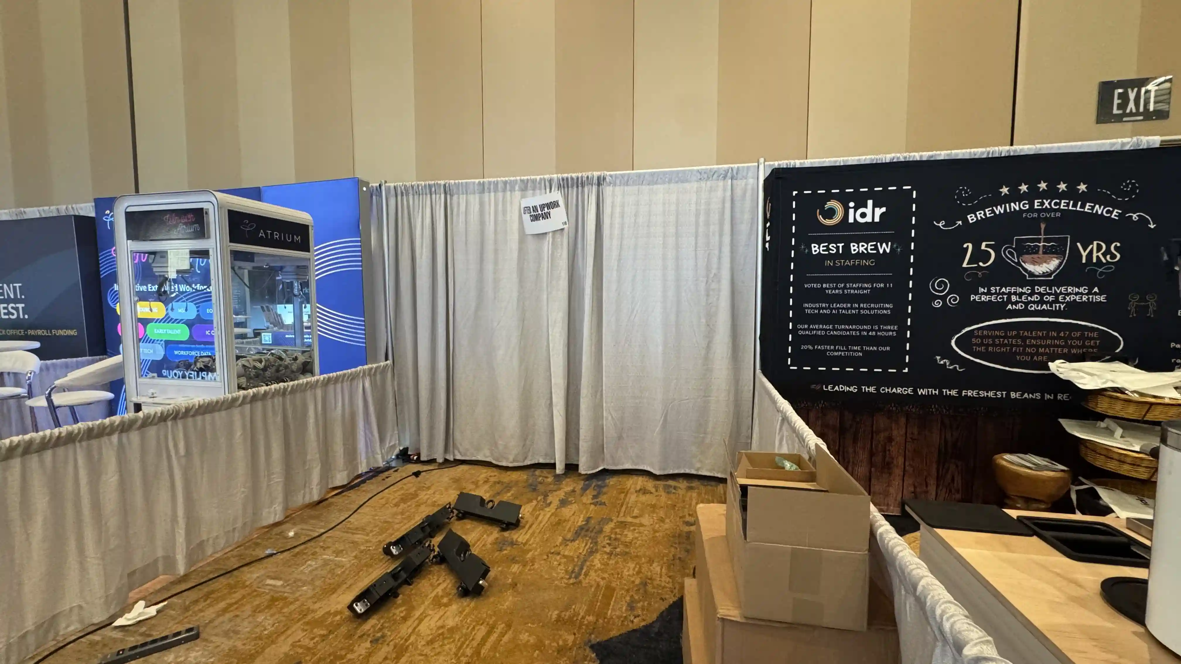 Lifted, an Upwork Company booth space with the CMG Visuals LED wall removed, drape and mounting hardware in place.