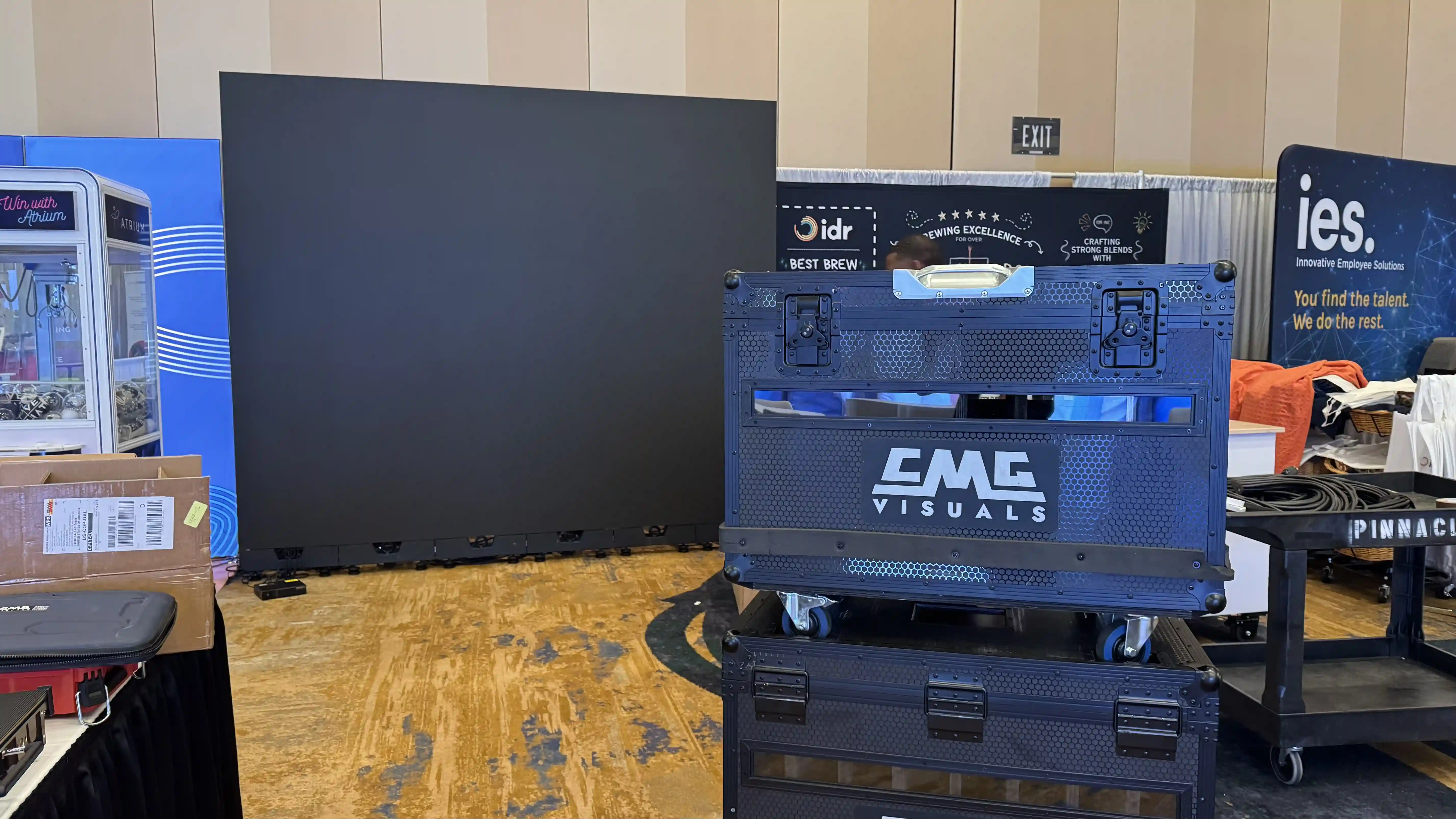 CMG Visuals flight case beside the indoor LED wall built for the Lifted, an Upwork Company trade show booth.