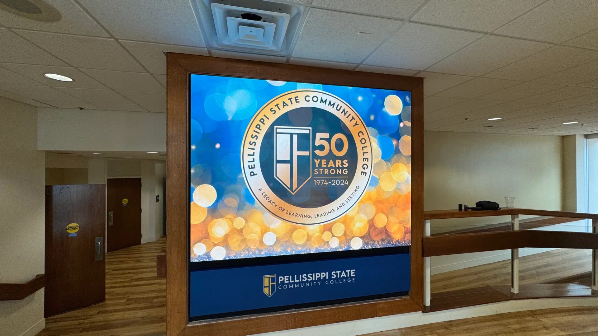 Indoor CMG Visuals LED wall in a wood frame showing Pellissippi State Community College's 50 Years Strong seal.