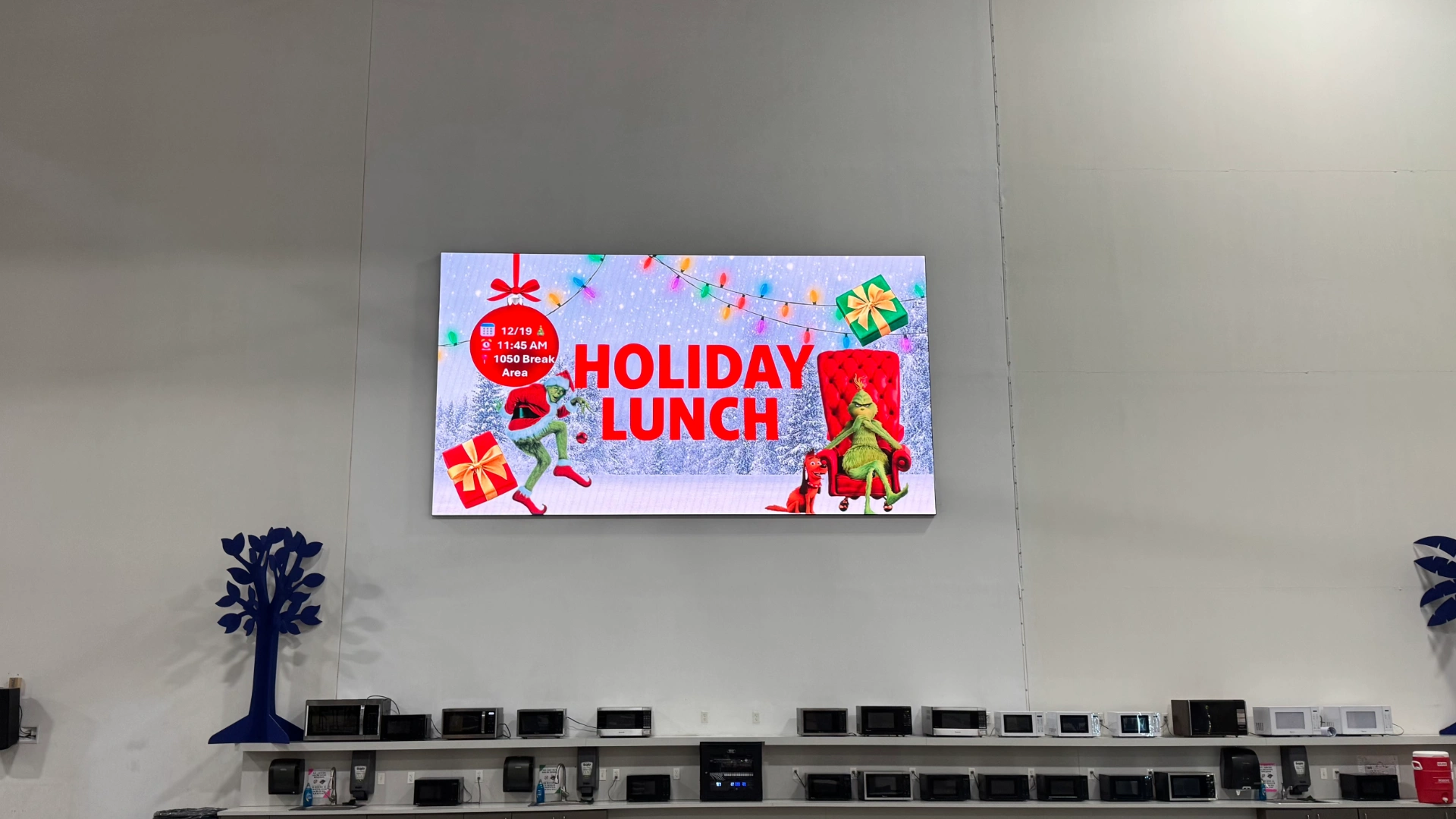 Permanent CMG Visuals LED wall showing a holiday event announcement in the Smith System employee break room.