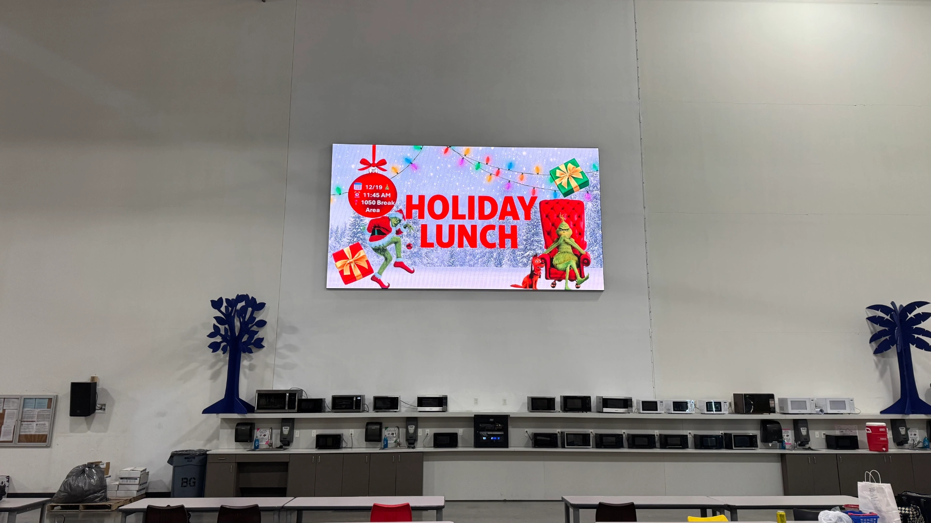 CMG Visuals indoor LED display mounted above the break area at Smith System, running an internal event announcement.