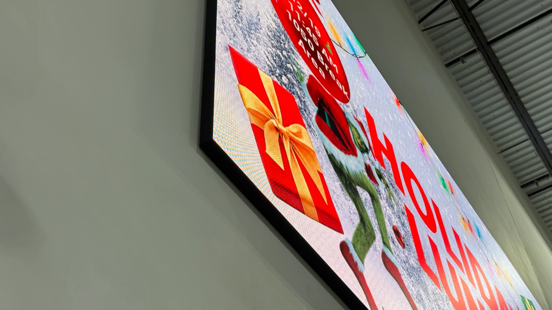 Close-up of the CMG Visuals indoor LED display mounted on the break room wall at Smith System.