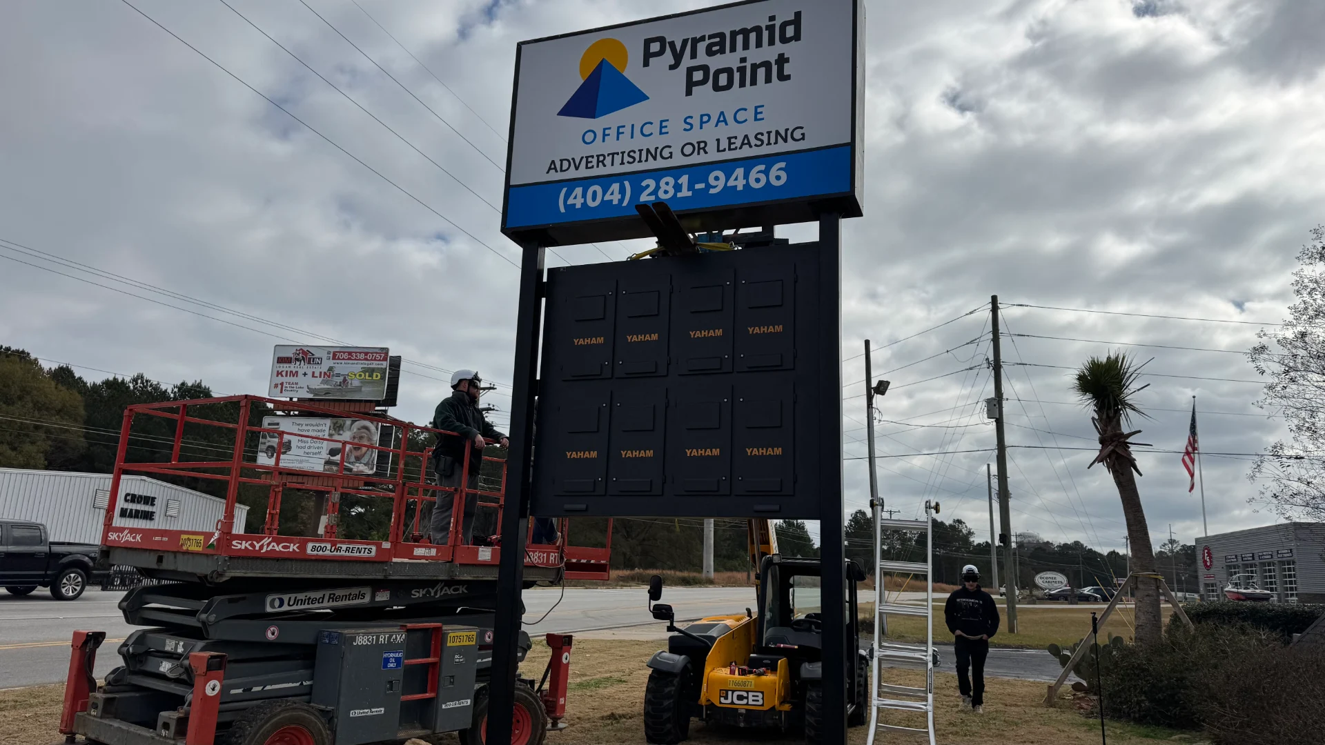 CMG Visuals crew building the outdoor LED pylon sign panel by panel at Pyramid Point in Greensboro. 