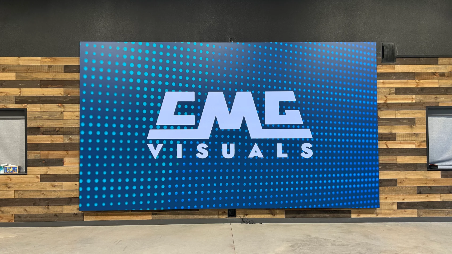 Finished CMG Visuals indoor LED wall on a wood accent wall
