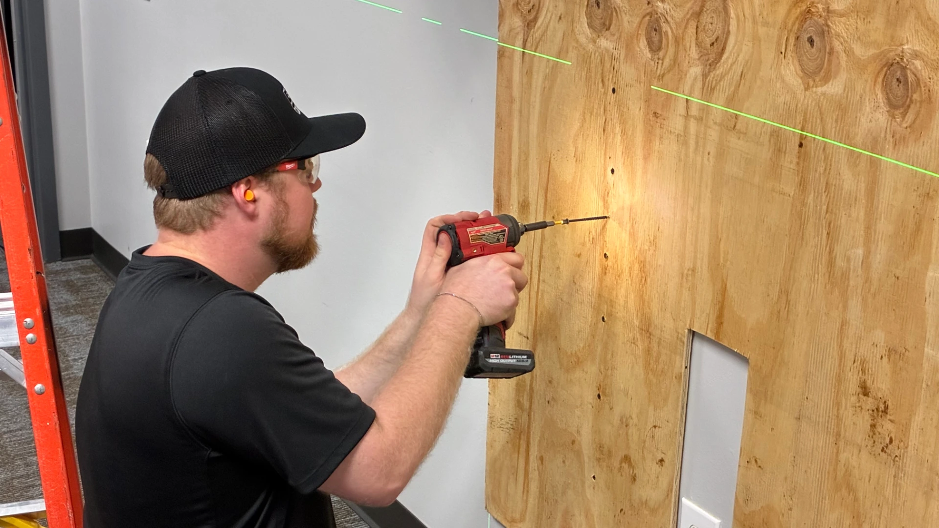 CMG Visuals technician mounting the backing for an indoor LED wall