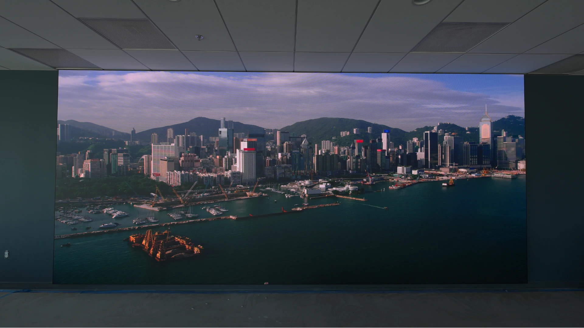 CMG Visuals indoor LED video wall showing a city skyline in a office.