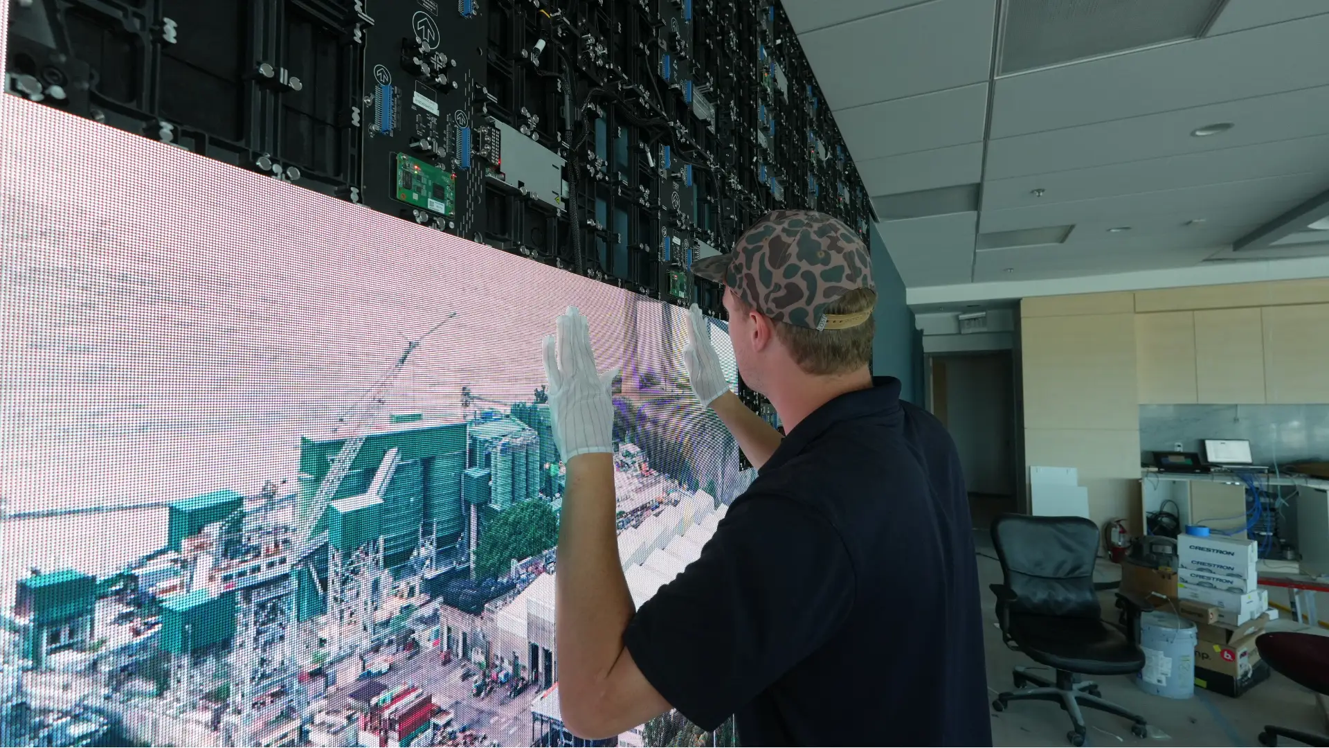 CMG Visuals technician installing the indoor LED wall panel by panel.