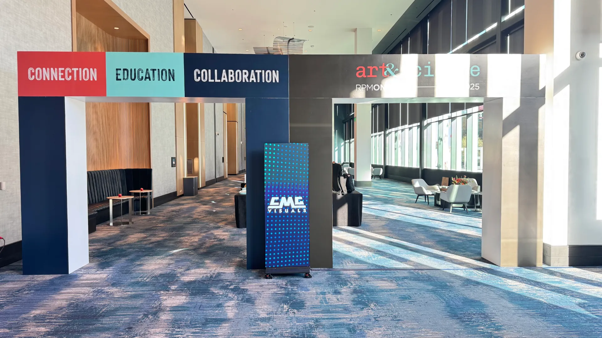 CMG Visuals vertical LED display at an event in a convention space.