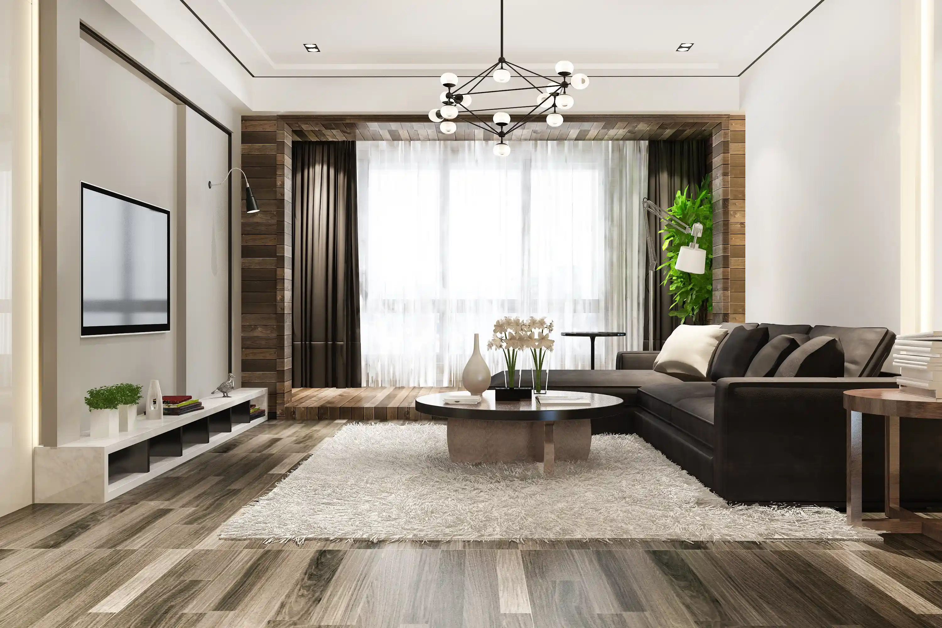 Modern living room with dark sectional sofa, geometric chandelier, and wood-look flooring.