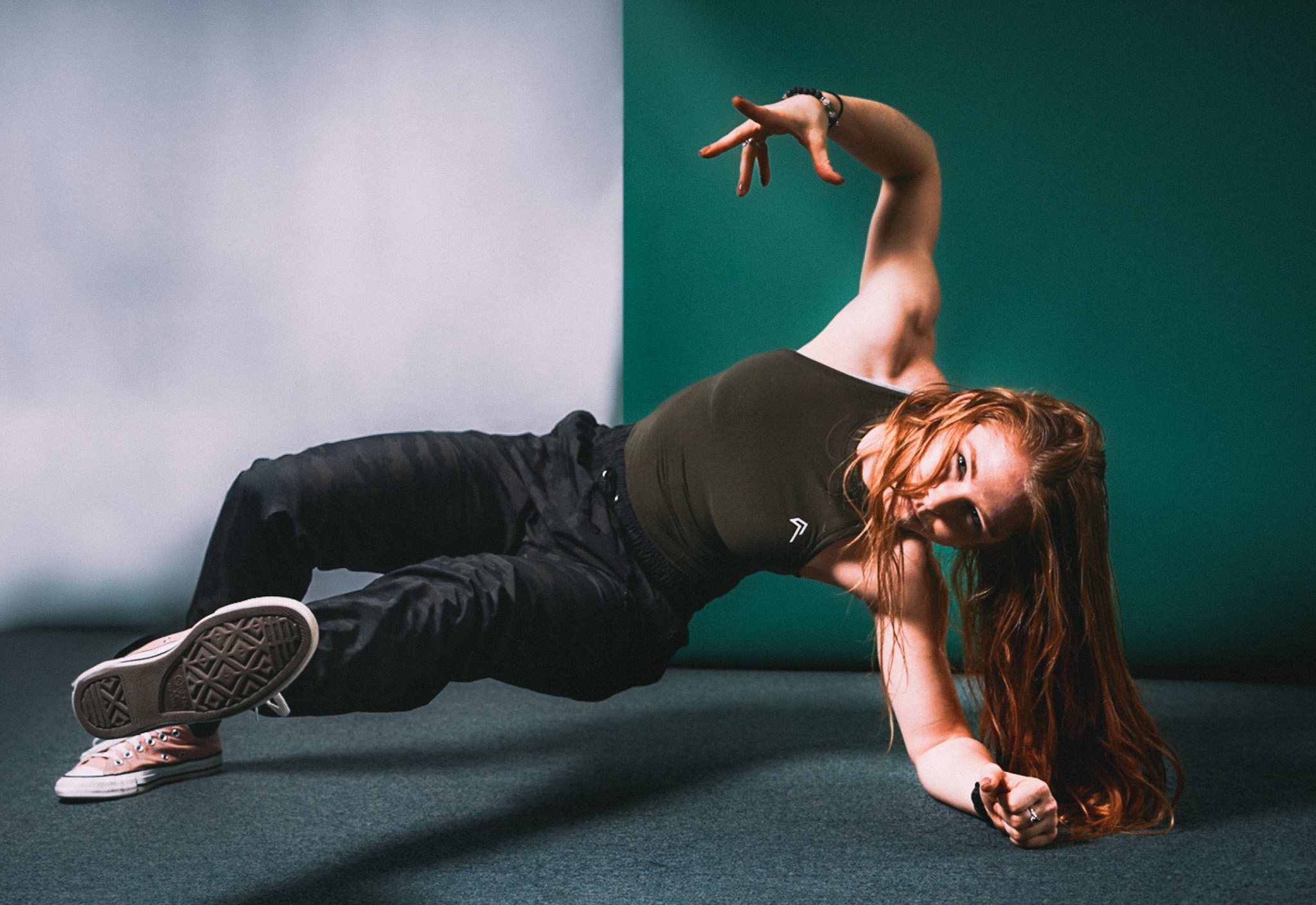 A dancer posing on forearm during photoshoot