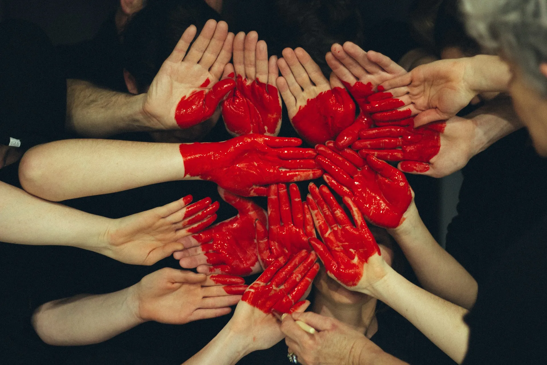 Numerous hands joining together to make a heart shape