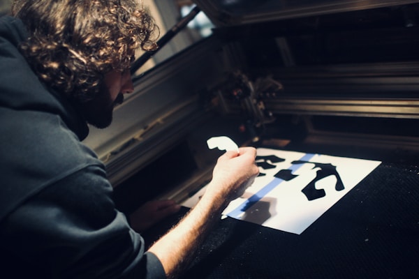 An engineer uses the laser cutting machine to test flat patterns.