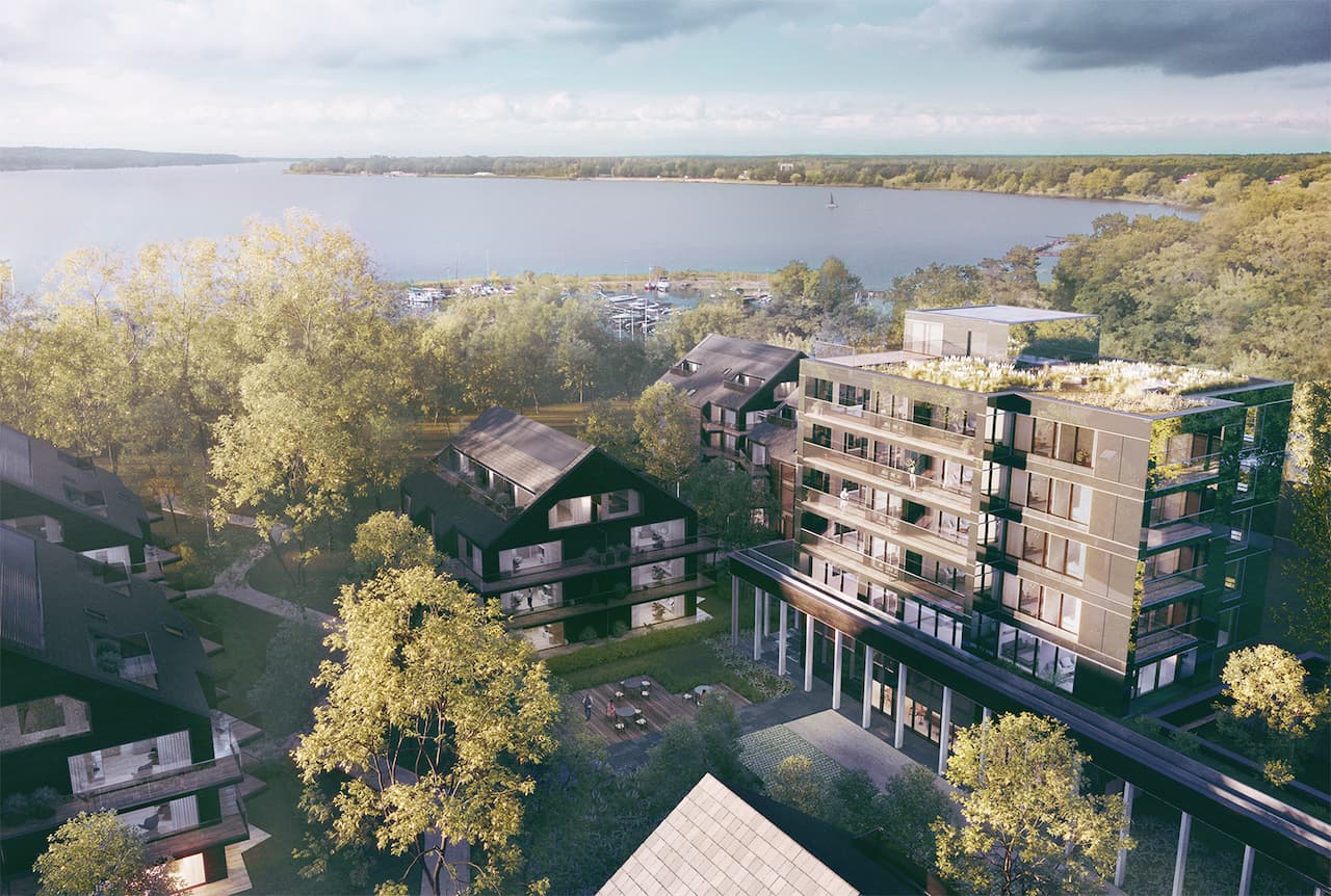 Widok z ostatniego piętra apartamentowca w Białorzegach, widac jezioro marinę i zieleń starodrzewu