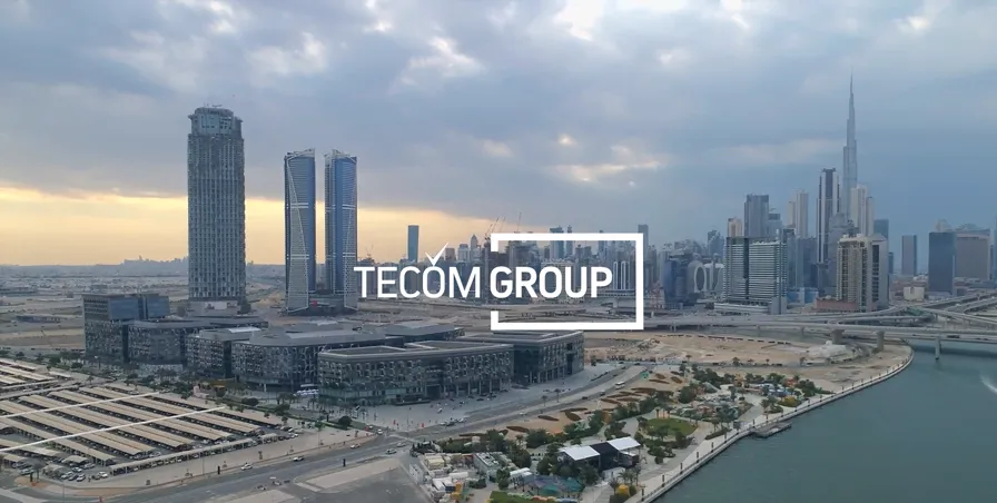 TECOM Group banner with office buildings landscape
