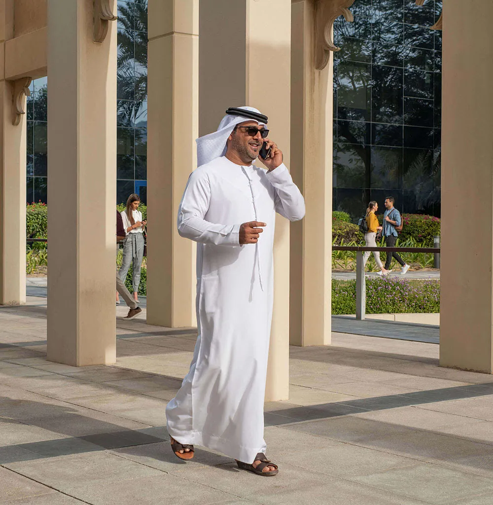 an Arab man speaking on phone