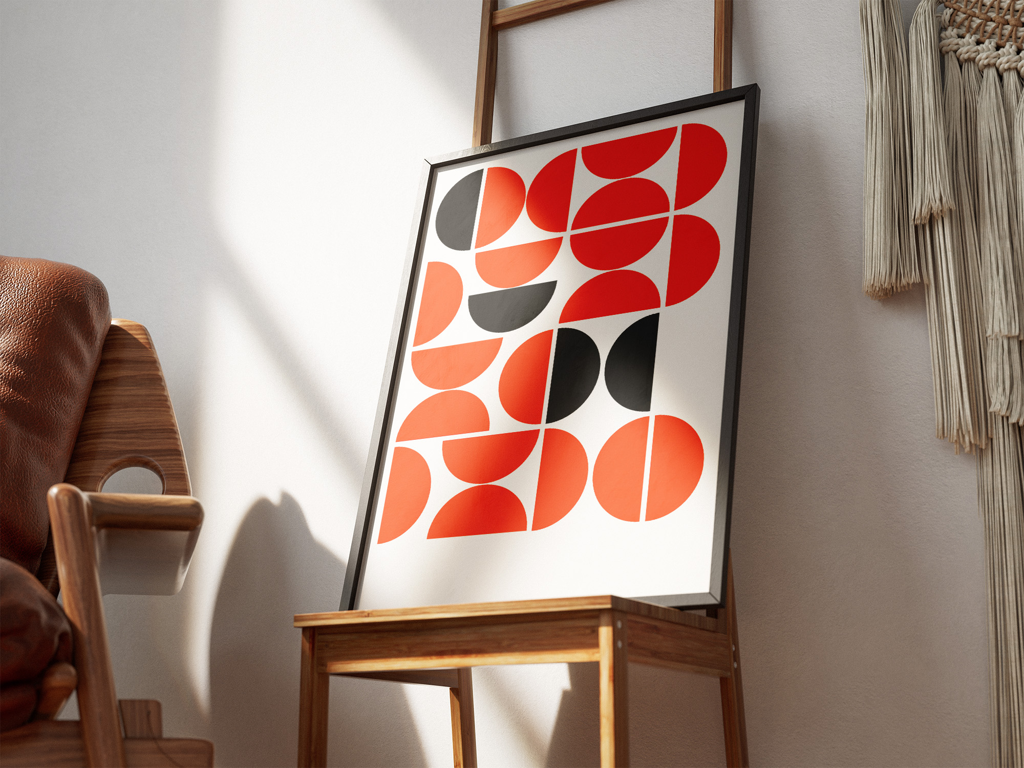A chair and a picture hanging on a wall.