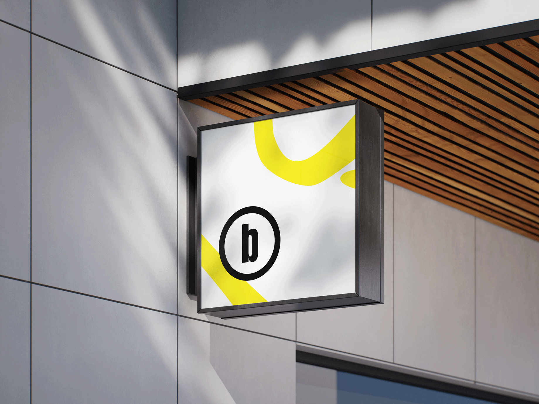 A white sign hanging from the side of a brick building.