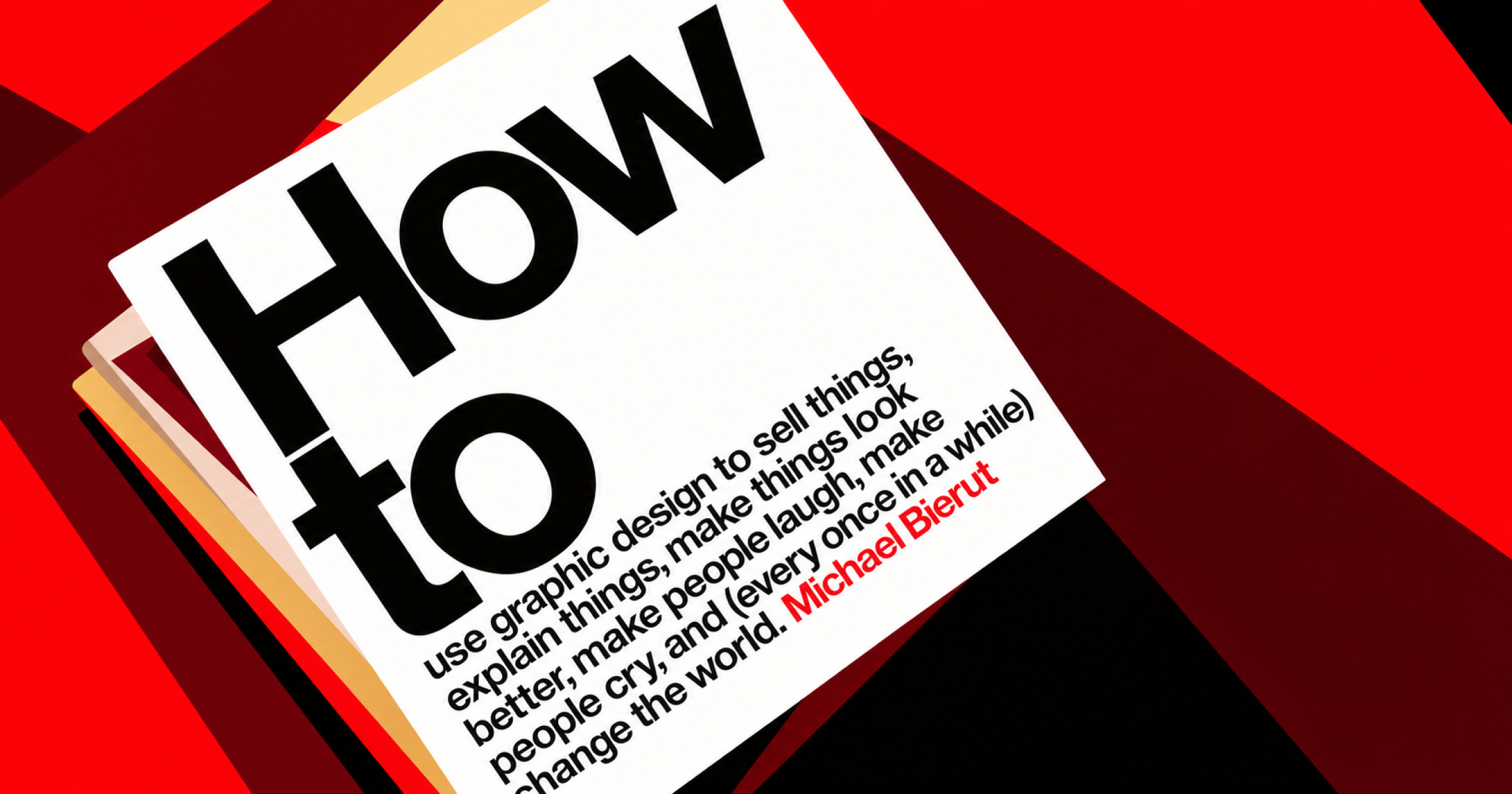 Livre « How To » posé sur une table, avec une couverture graphique rouge, noire et blanche.