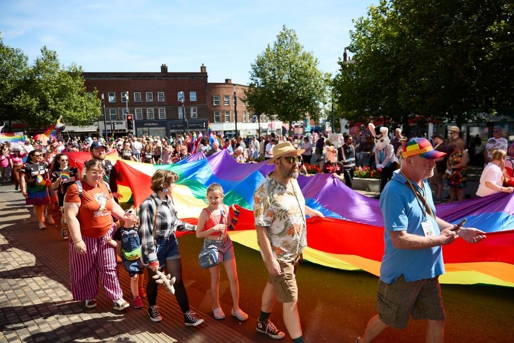 Two smiling Sheffield half marathon runners holding up their medals
