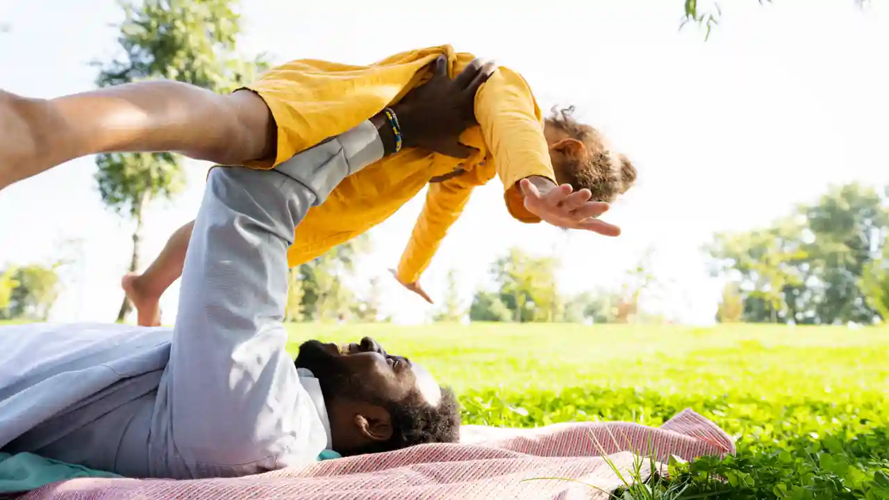 Outdoor parent-child play showing balance, a core focus of kids’ movement development and coordination