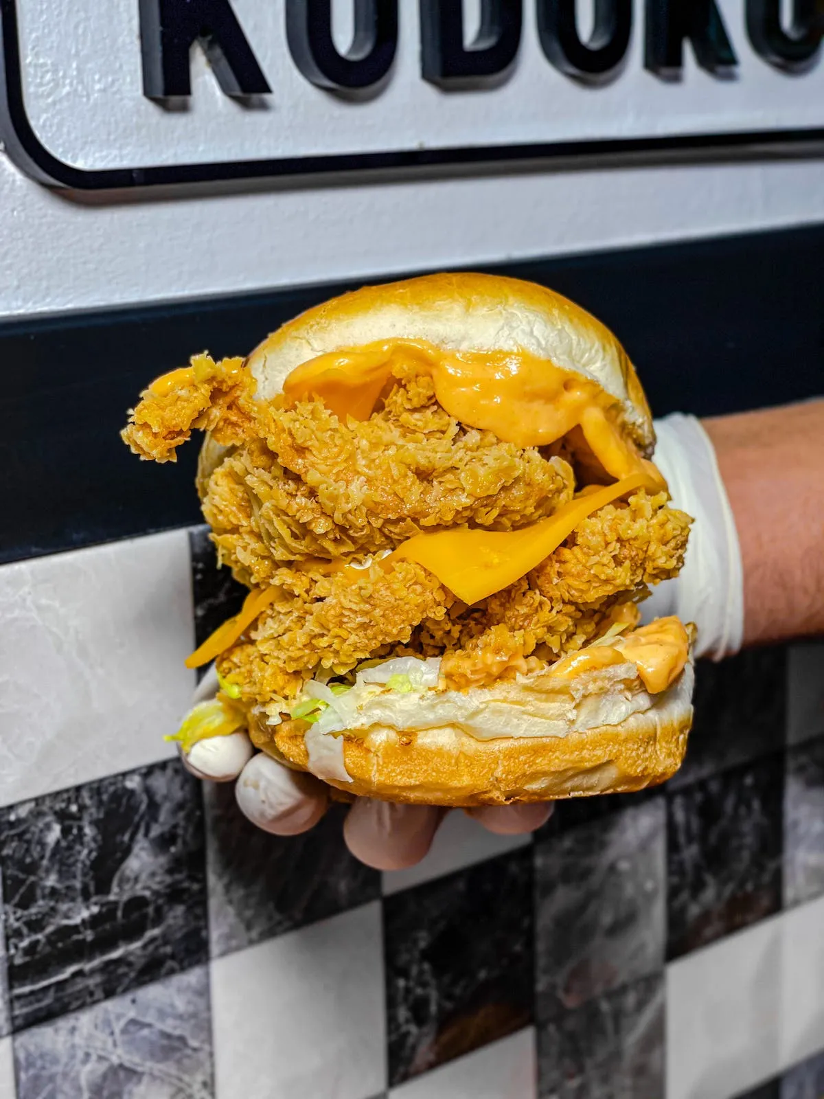 A hand holding a burger