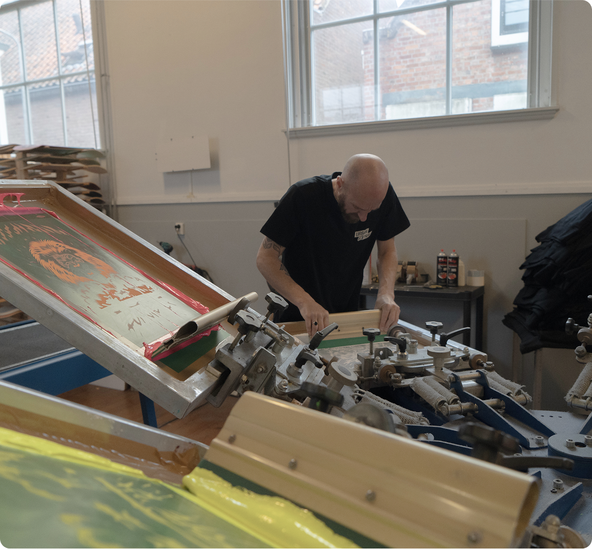 Man screen printing and manufacturing custom swag and tshirts. 