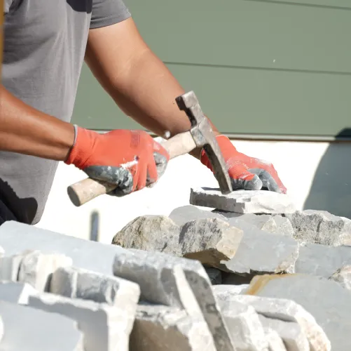 Mason working with stone